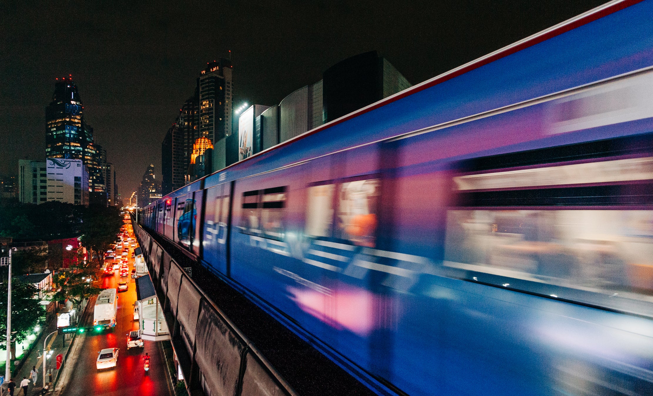 A night train speeds above traffic in Bangkok, Thailand