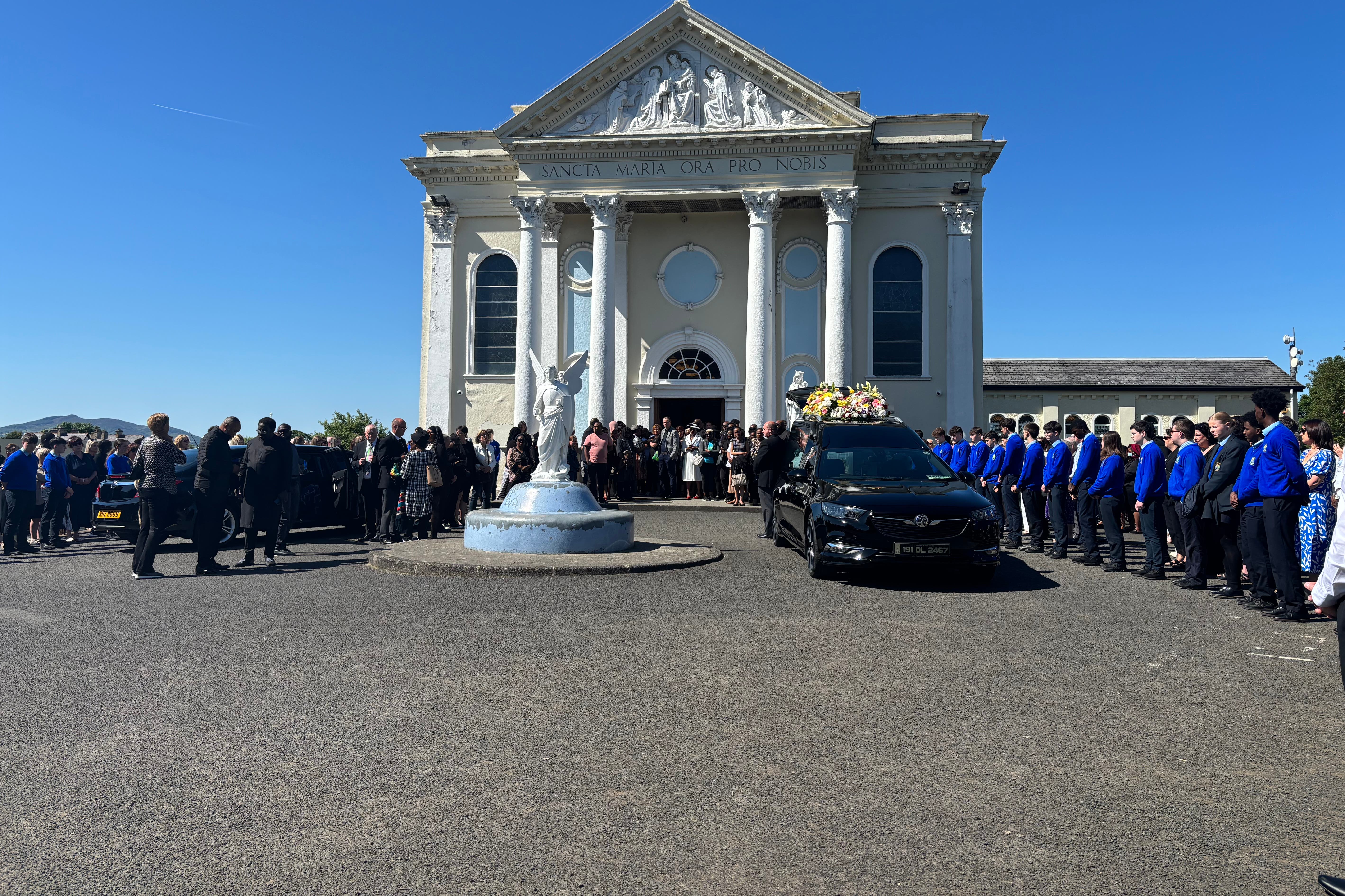Mourners outside St Mary’s Oratory in Buncrana following the funeral of teenager Emmanuel Familola (Rebecca Black/PA)