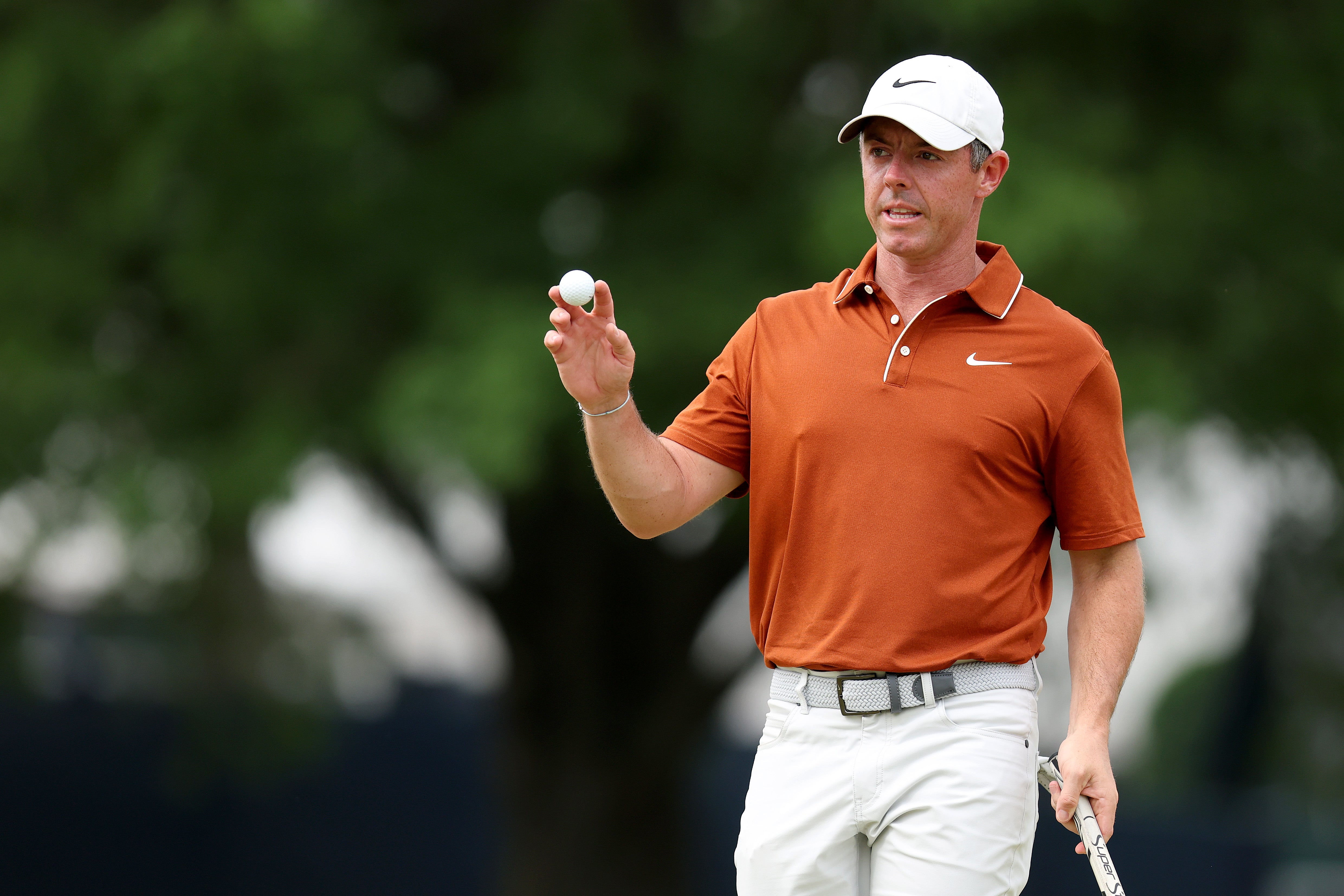 Rory McIlroy of Northern Ireland reacts to a putt on the 10th green