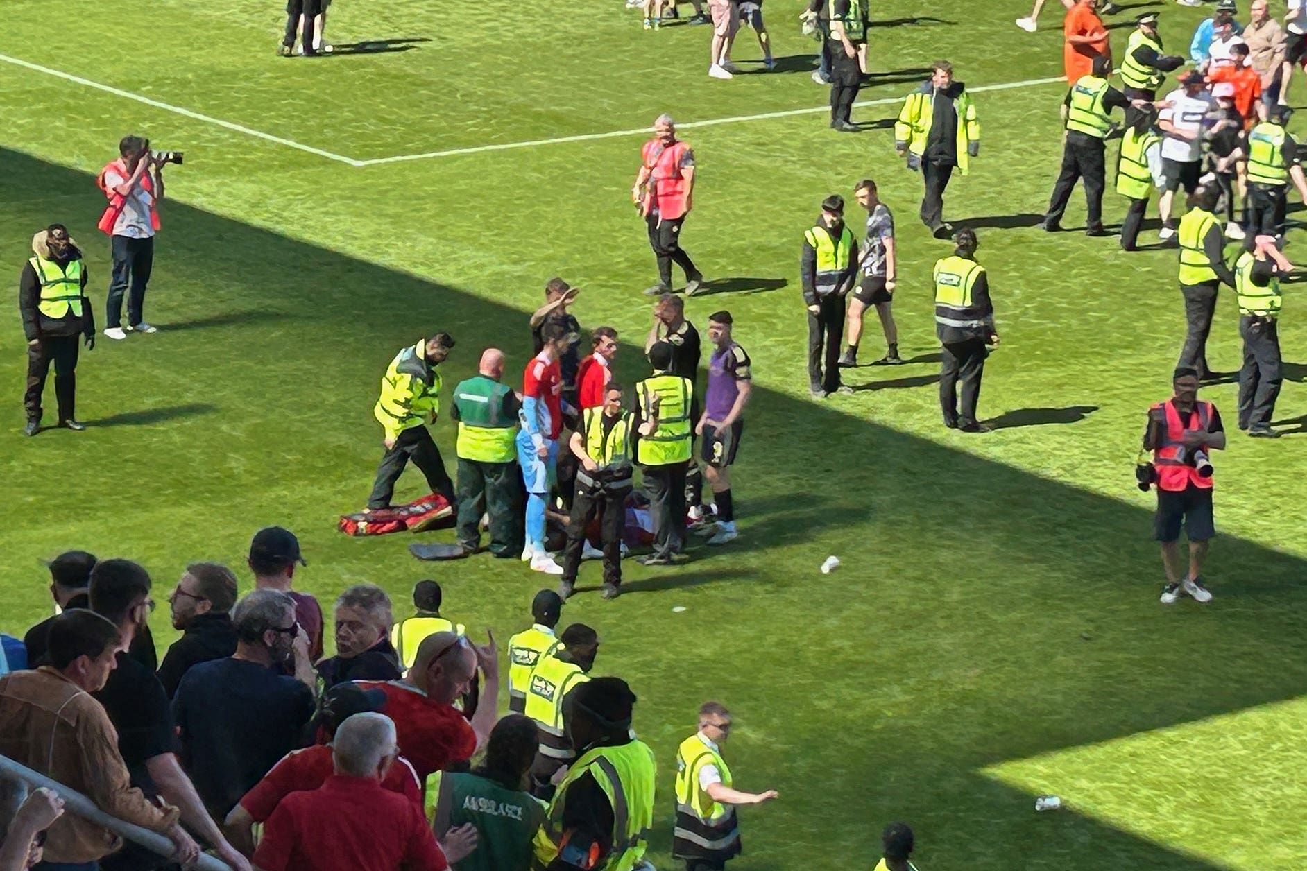 Aberdeen’s Jack MacKenzie got treatment on the pitch as fans invaded the pitch after Dundee United’s victory over Aberdeen