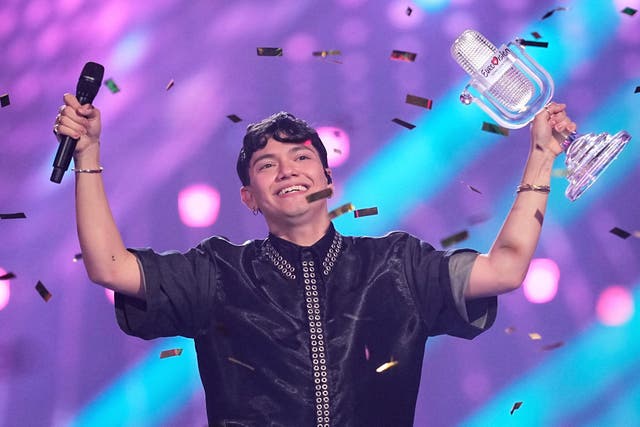 <p>Winner of the Eurovision Song Contest JJ from Austria holds up the trophy (Martin Meissner/AP)</p>