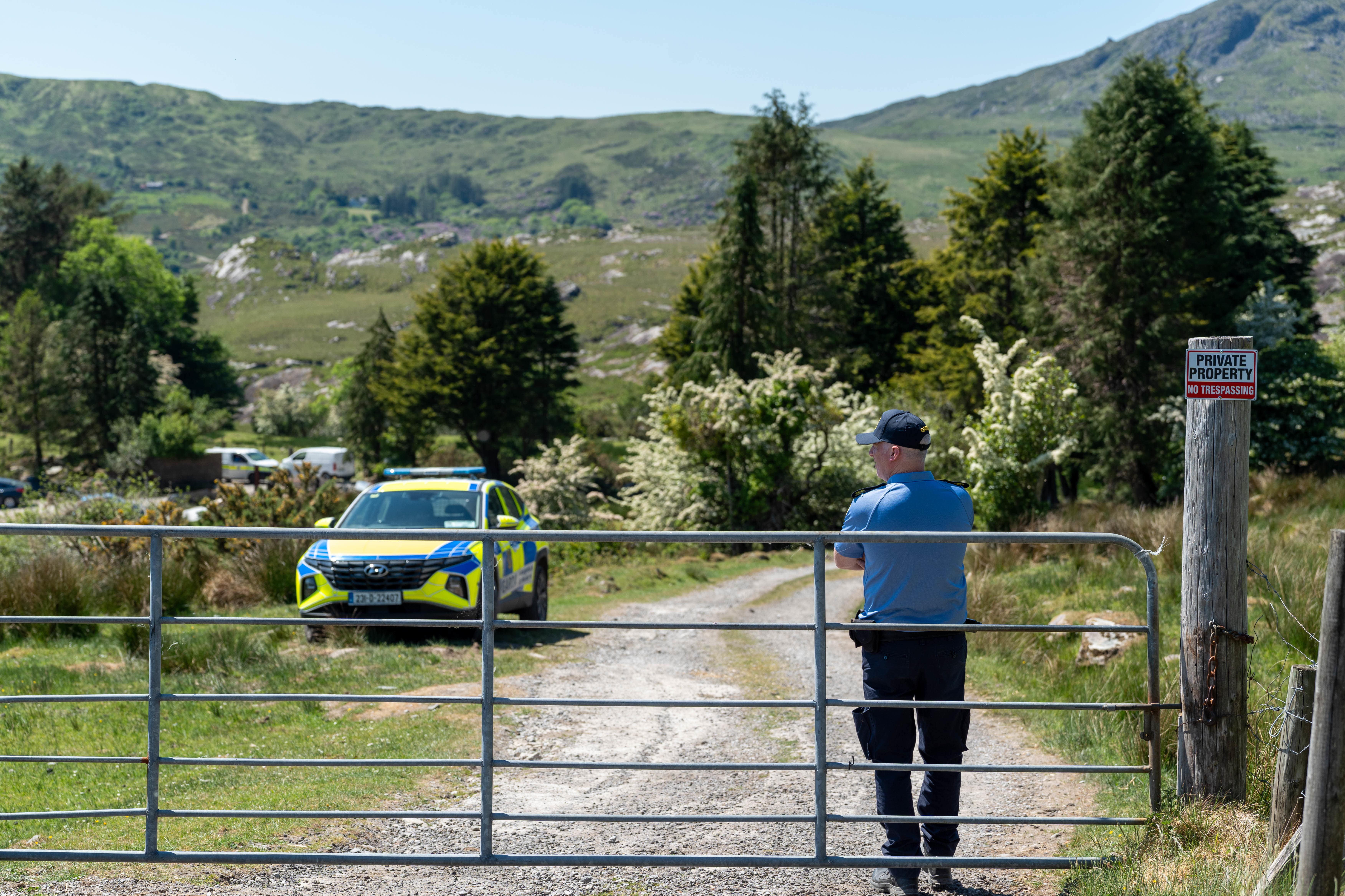 Gardai at the scene in Carrig East, Kenmare, investigating the disappearance of Co Kerry farmer Michael Gaine (Noel Sweeney/PA)