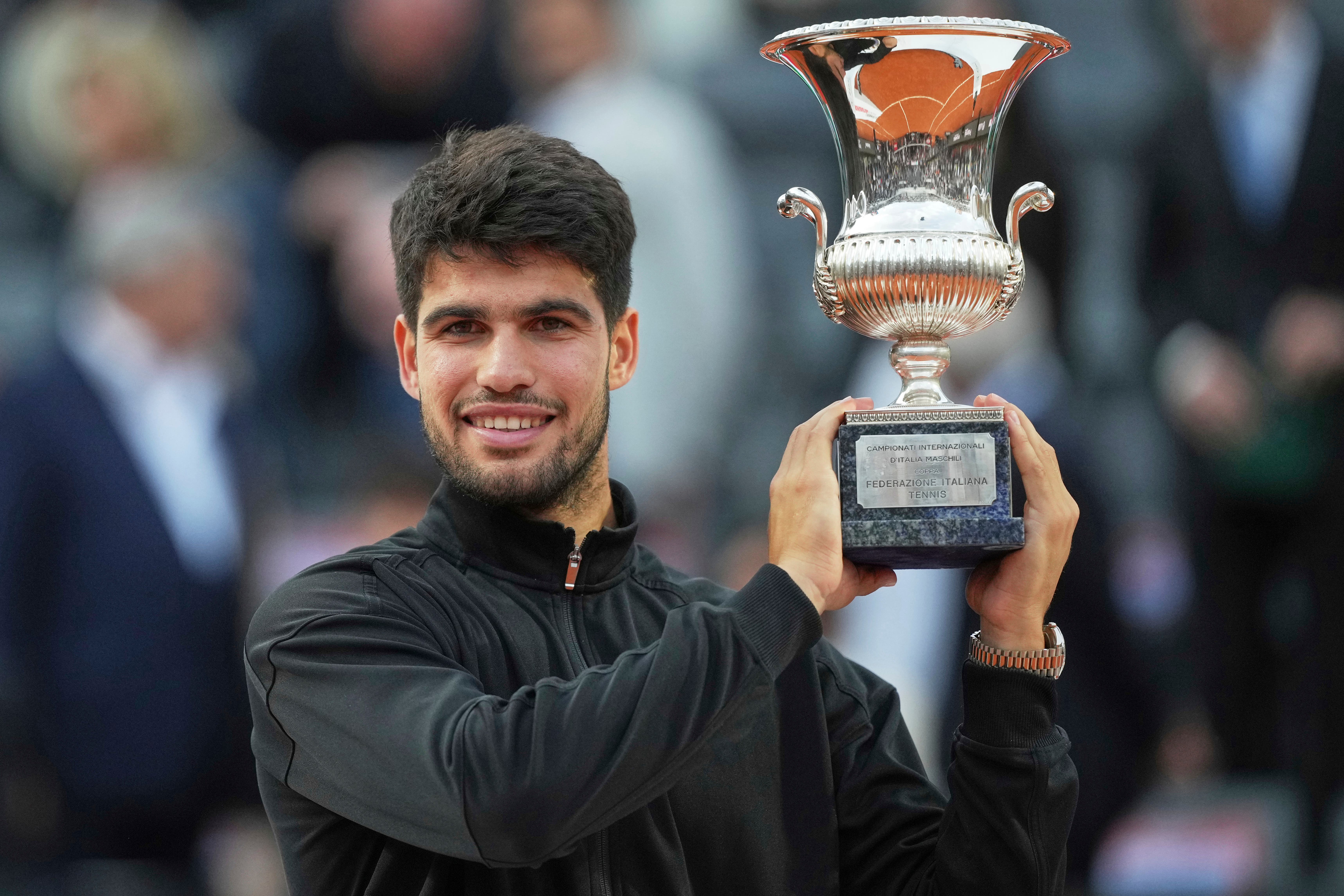 Carlos Alcaraz holds the trophy after winning the Italian Open in Rome