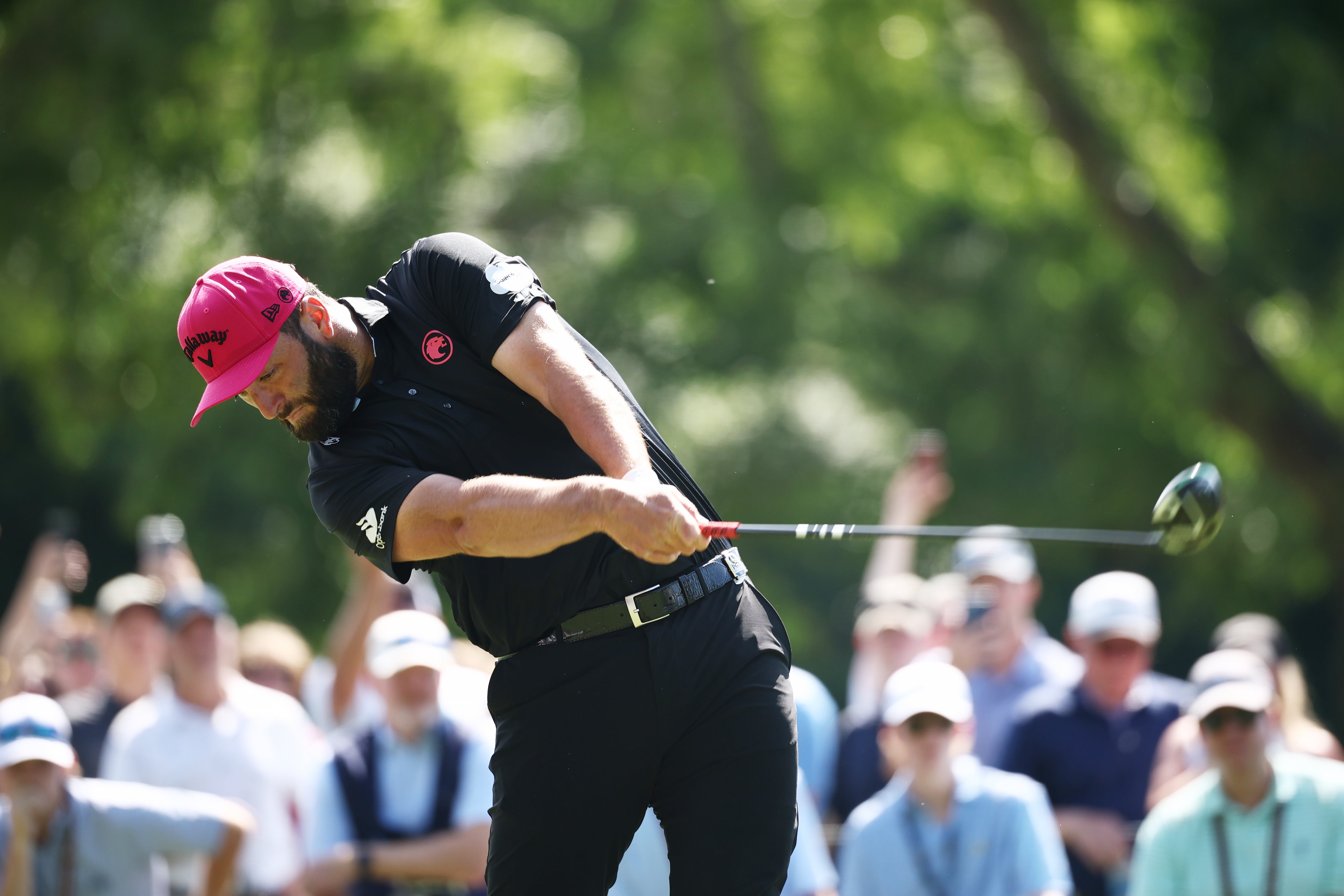 Jon Rahm drives on the ninth tee