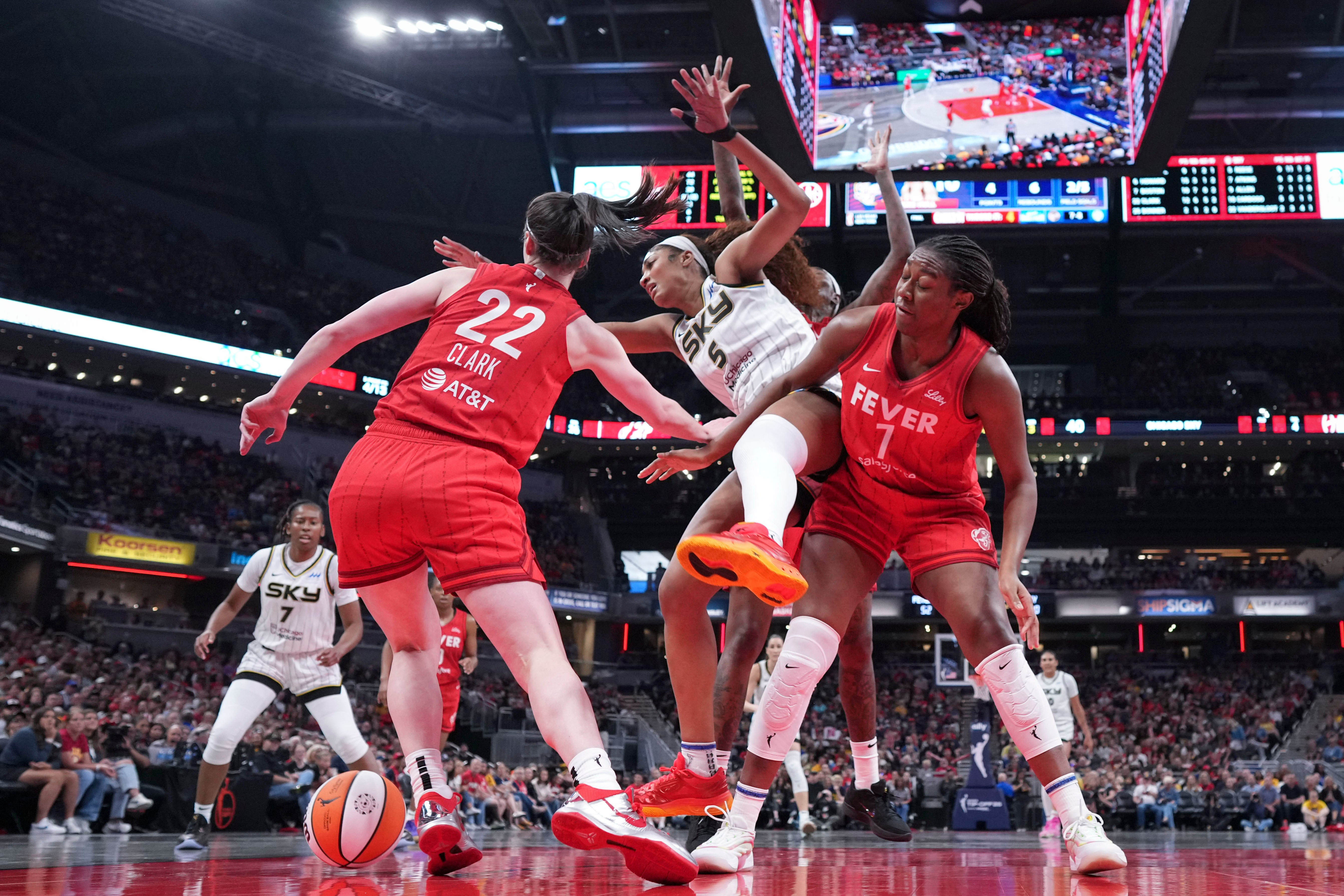 Indiana Fever guard Caitlin Clark, left, battles for the ball with Chicago Sky forward Angel Reese
