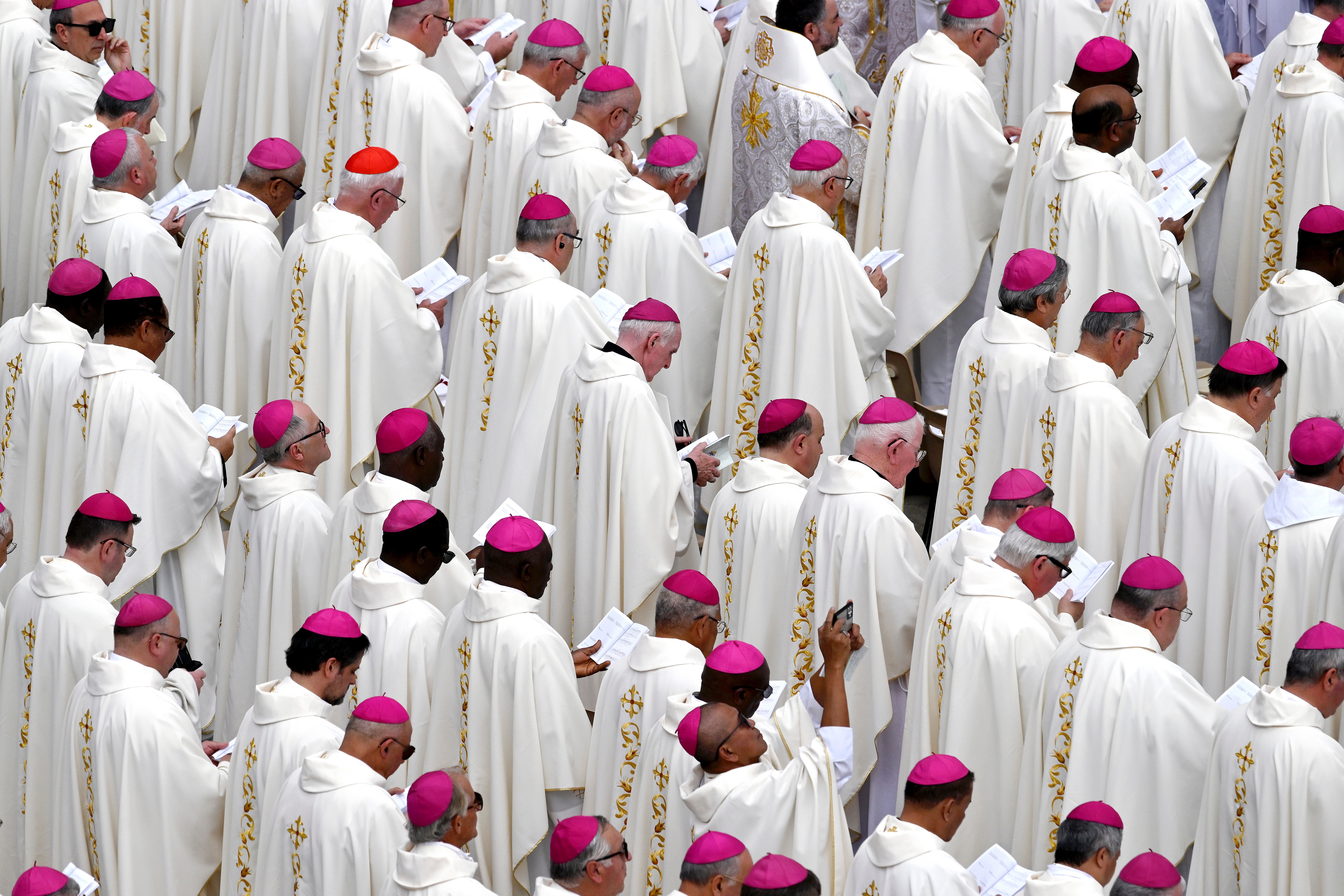 The clergy pray during the inauguration mass of Pope Leo XIV