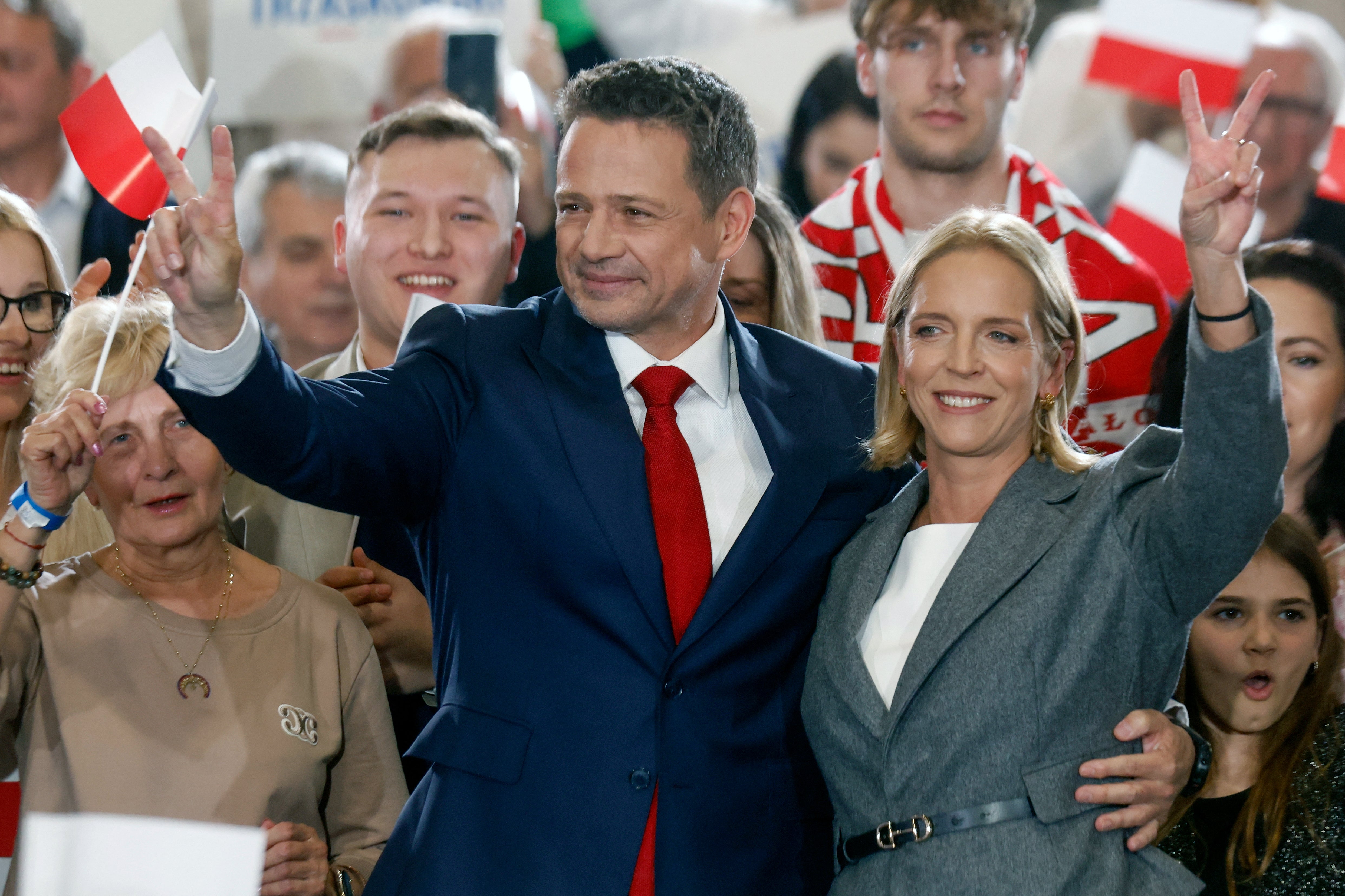Karol Nawrocki, backed by Poland's right-wing Law and Justice (PiS) party, waves to supporters with his wife in Gdansk after a better-than-expected result in first-round voting