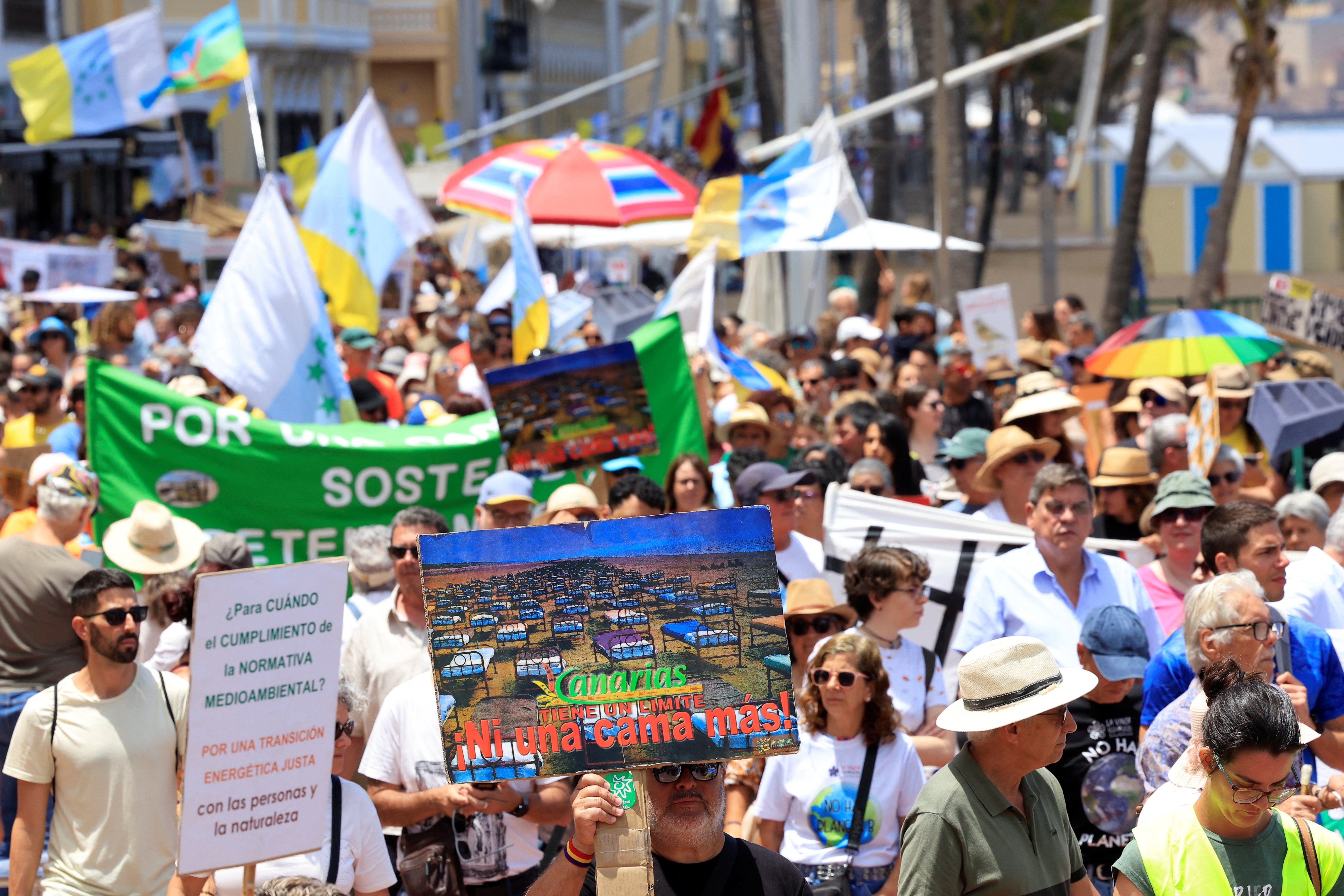 People gather during a demonstration calling for a change in the tourism model in the Canary Islands, in Las Palmas de Gran Canaria