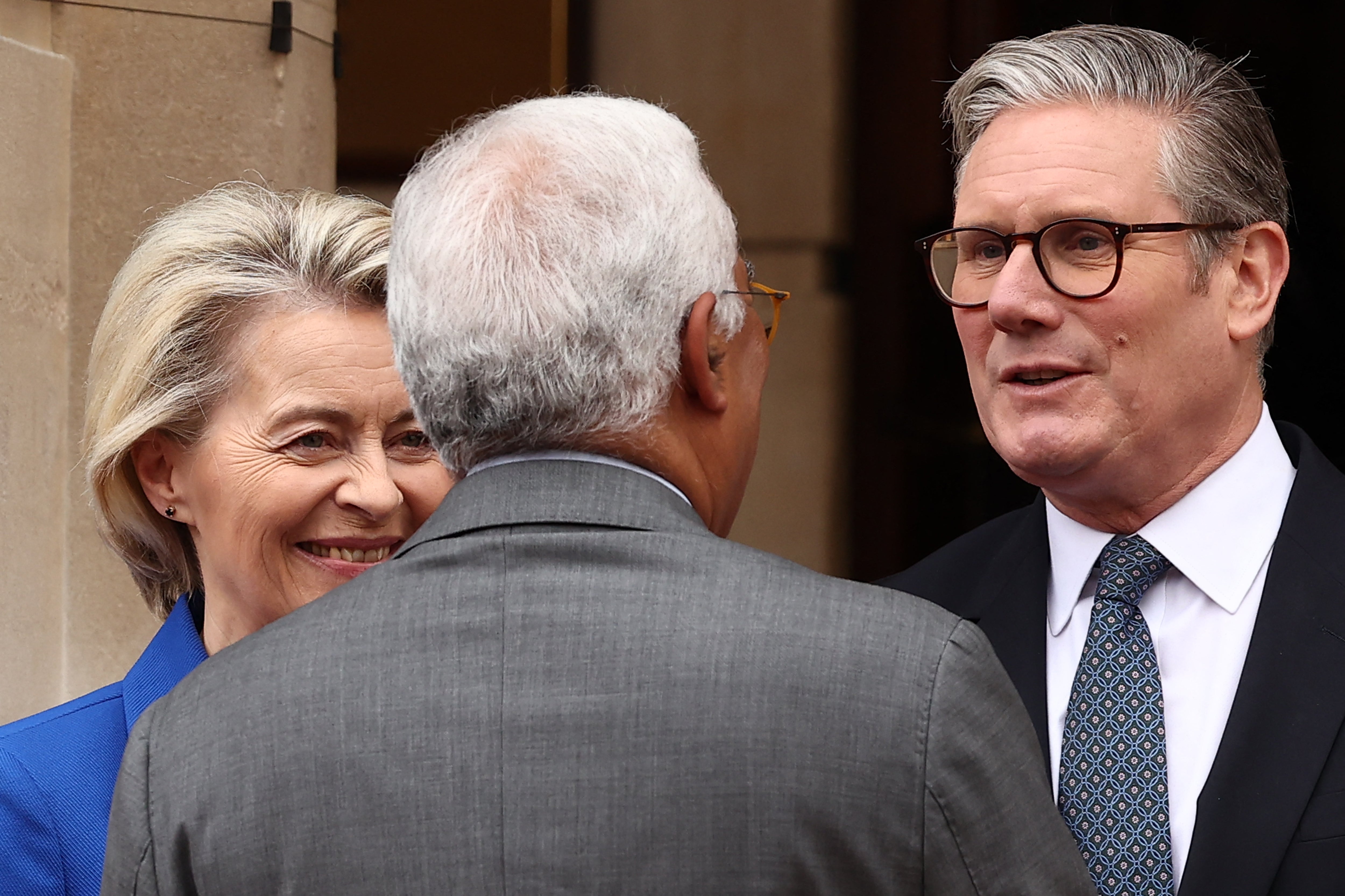 Britain's Prime Minister Keir Starmer (R) greets European Commission President Ursula von der Leyen and European Council President Antonio Costa as they arrive to attend the UK-EU Summit at Lancaster House in London on May 19, 2025
