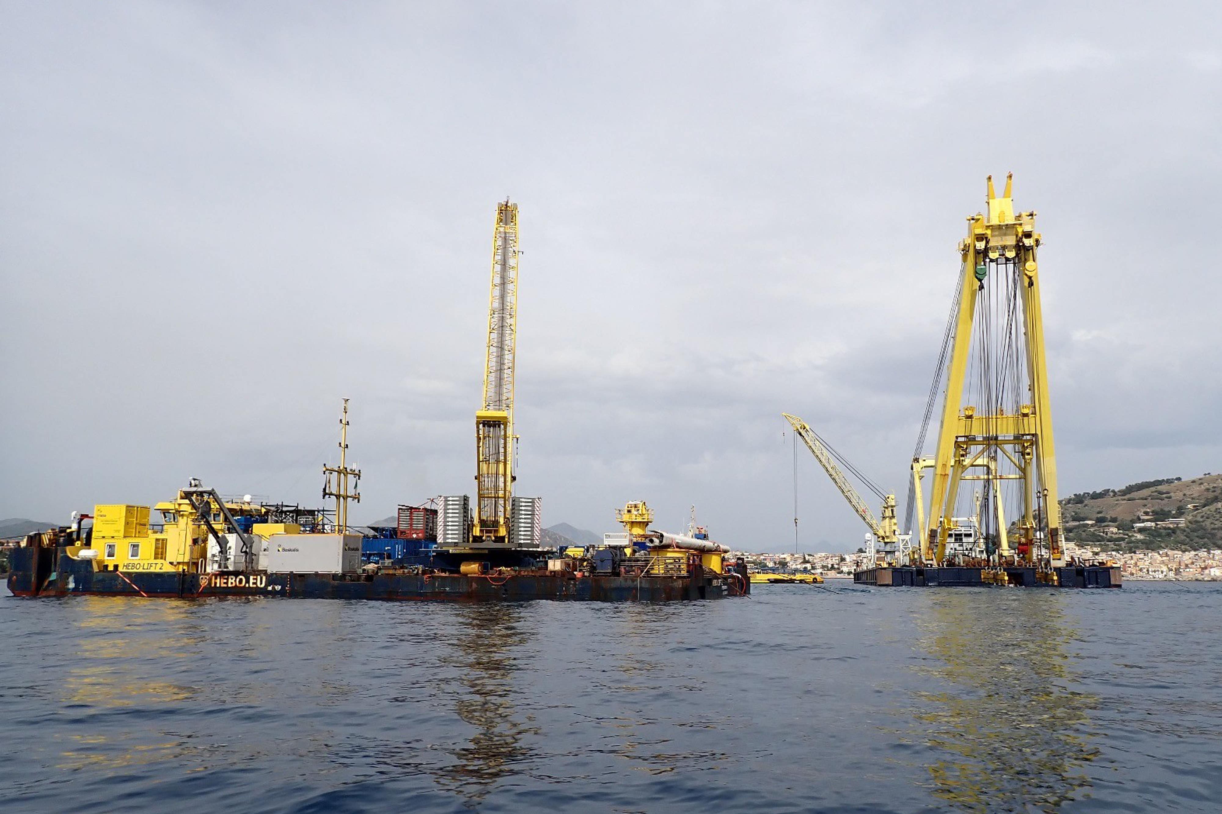 Cranes being used to bring the sunken Bayesian yacht to the surface in Sicily