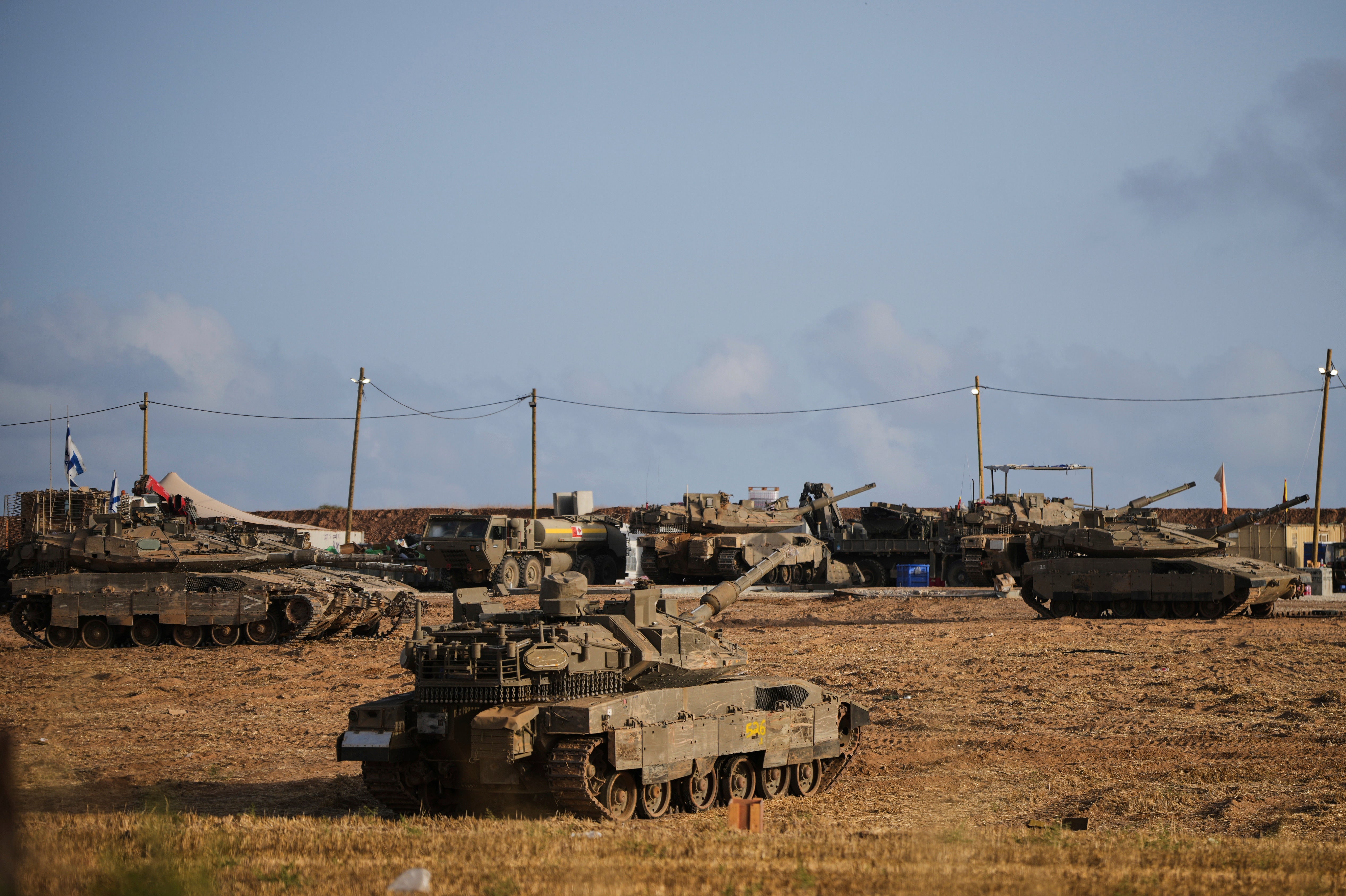 Israeli tanks seen at a staging area near the border with the Gaza Strip, in southern Israel (Ohad Zwigenberg/AP)