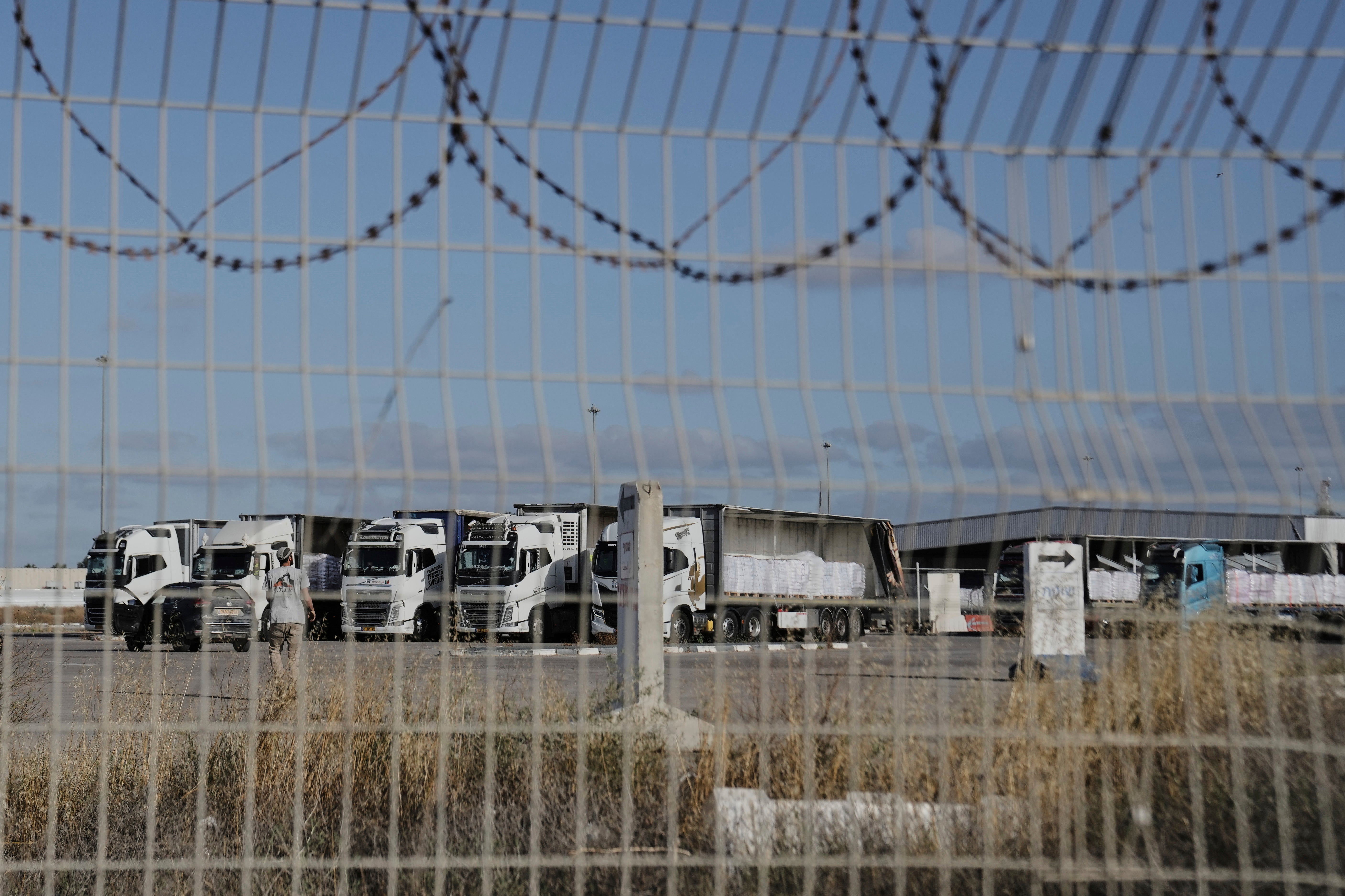 Trucks load with humanitarian aid for the Gaza Strip are seen at the Kerem Shalom Crossing in southern Israel, Tuesday May 20