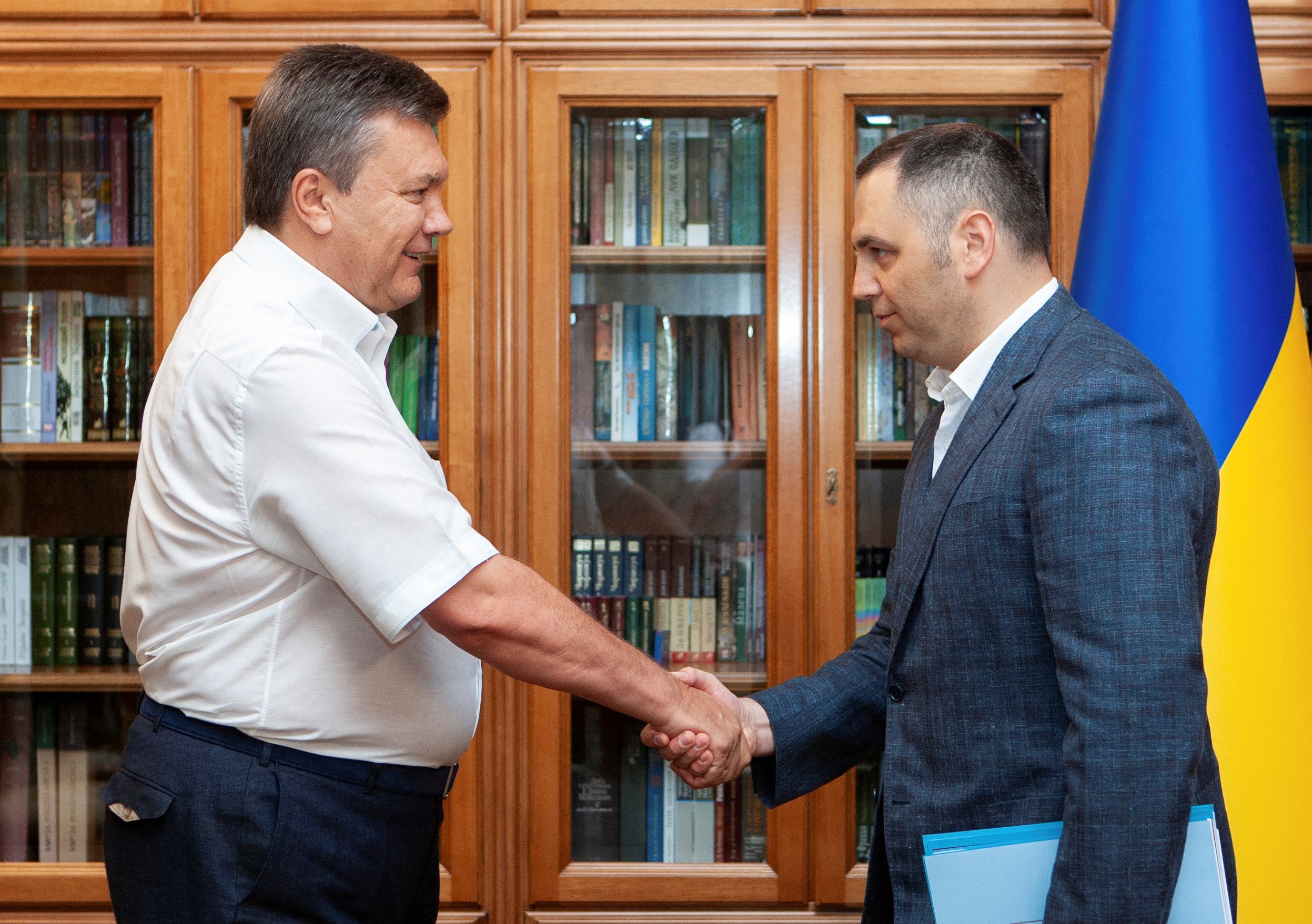 Viktor Yanukovych and Andriy Portnov, shake hands in Kyiv, Ukraine