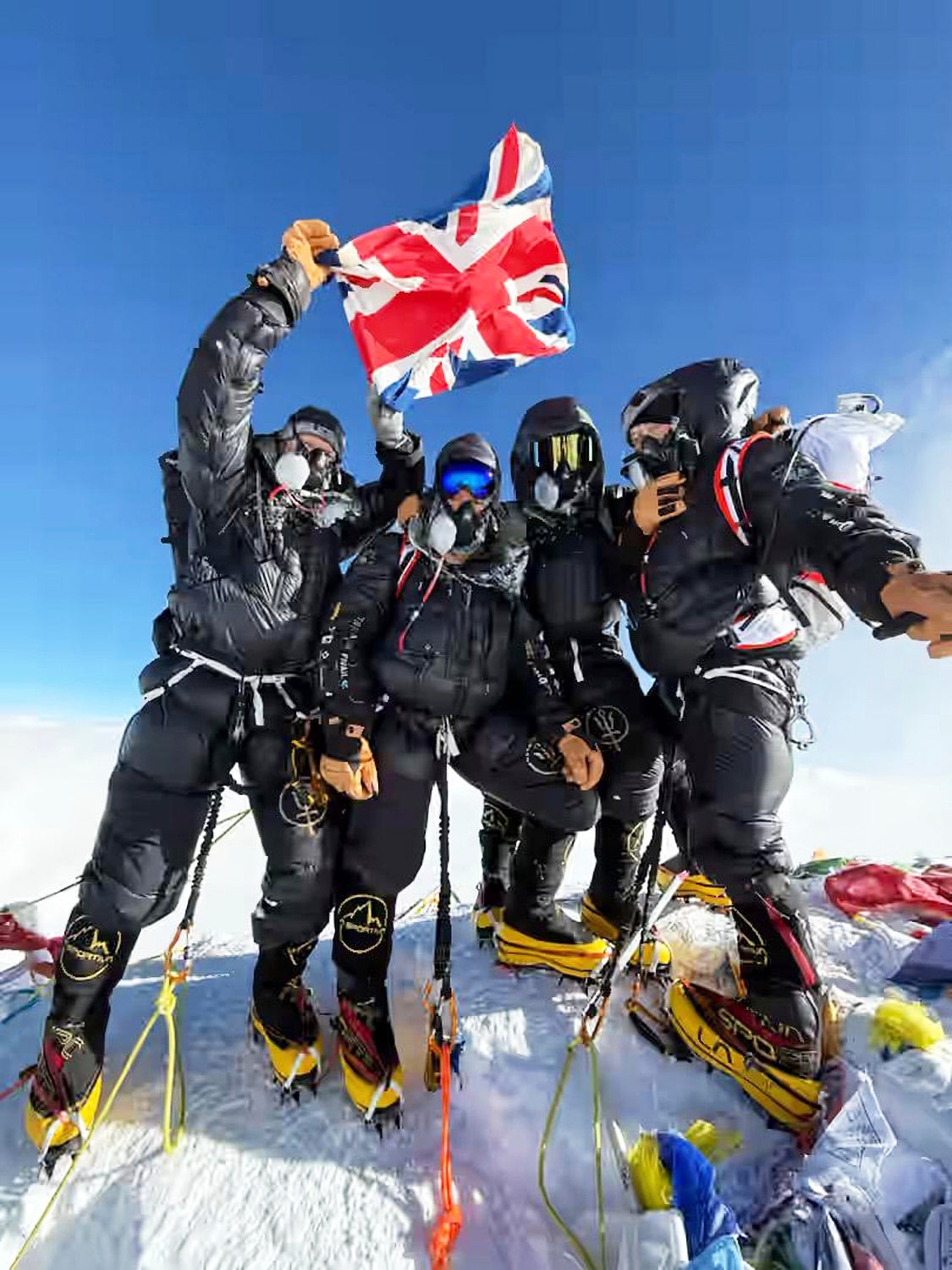 Four British climbers pose on the summit of Mount Everest less than a week after leaving London, in one of the fastest ascents on record of the world's highest peak, in Nepal, Wednesday, May 21, 2025. (Sandro Gromen via AP)