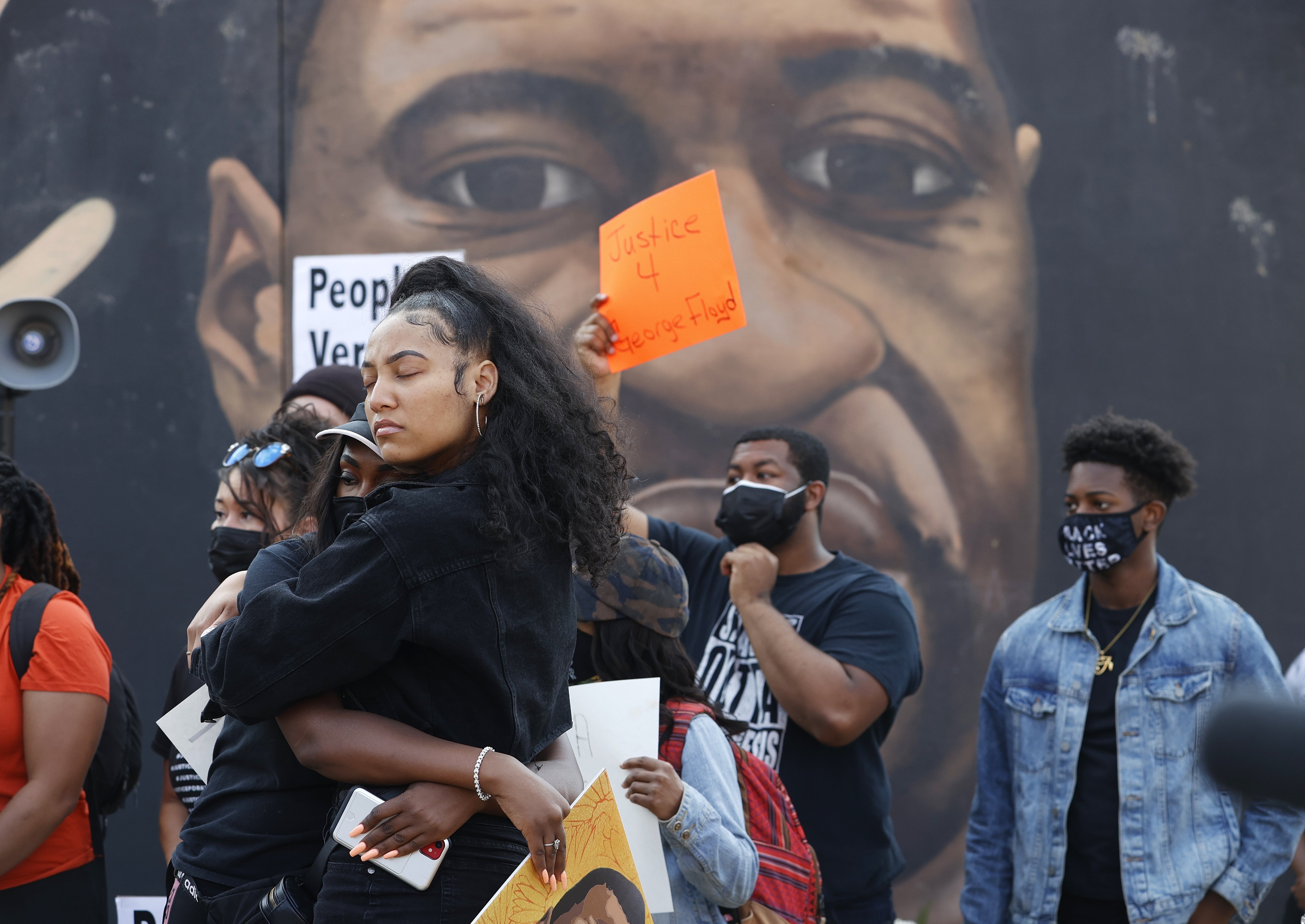 Demonstrators stand by a mural of George Floyd after former Minneapolis Police Department officer Derek Chauvin was found guilty of his murder on April 20, 2021. Federal officials have dropped an civil rights investigation into Minneapolis police and other local law enforcement agencies.
