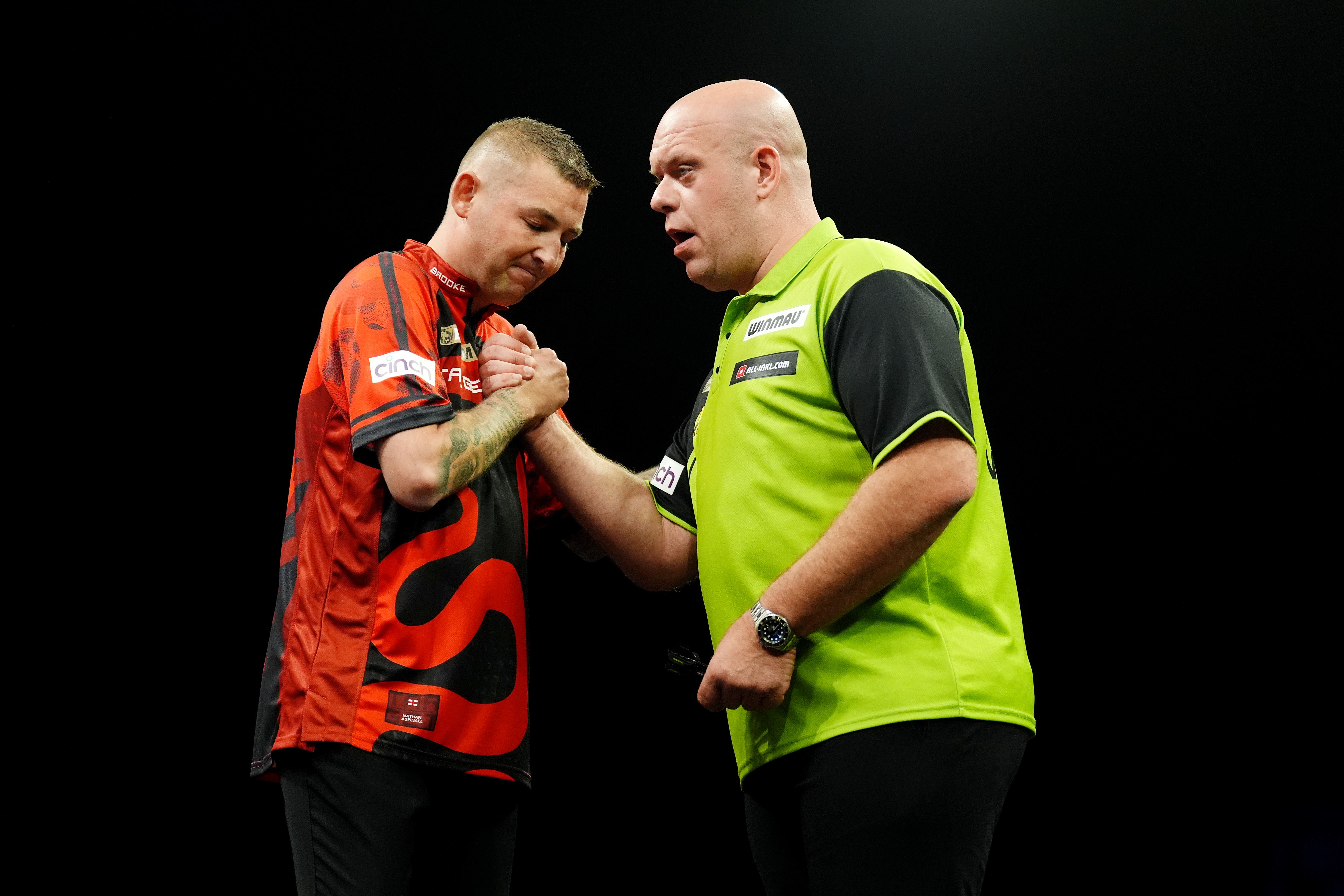 Nathan Aspinall, left, takes on Michael van Gerwen in a crunch encounter in Sheffield (Andrew Milligan/PA)