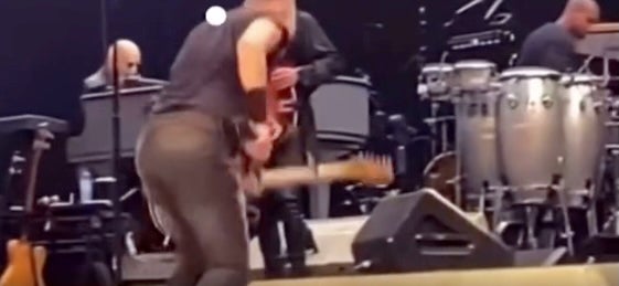 Springsteen took a tumble after being hit by the fake golf ball in the video. The president and the rock star have been in a feud in recent days.