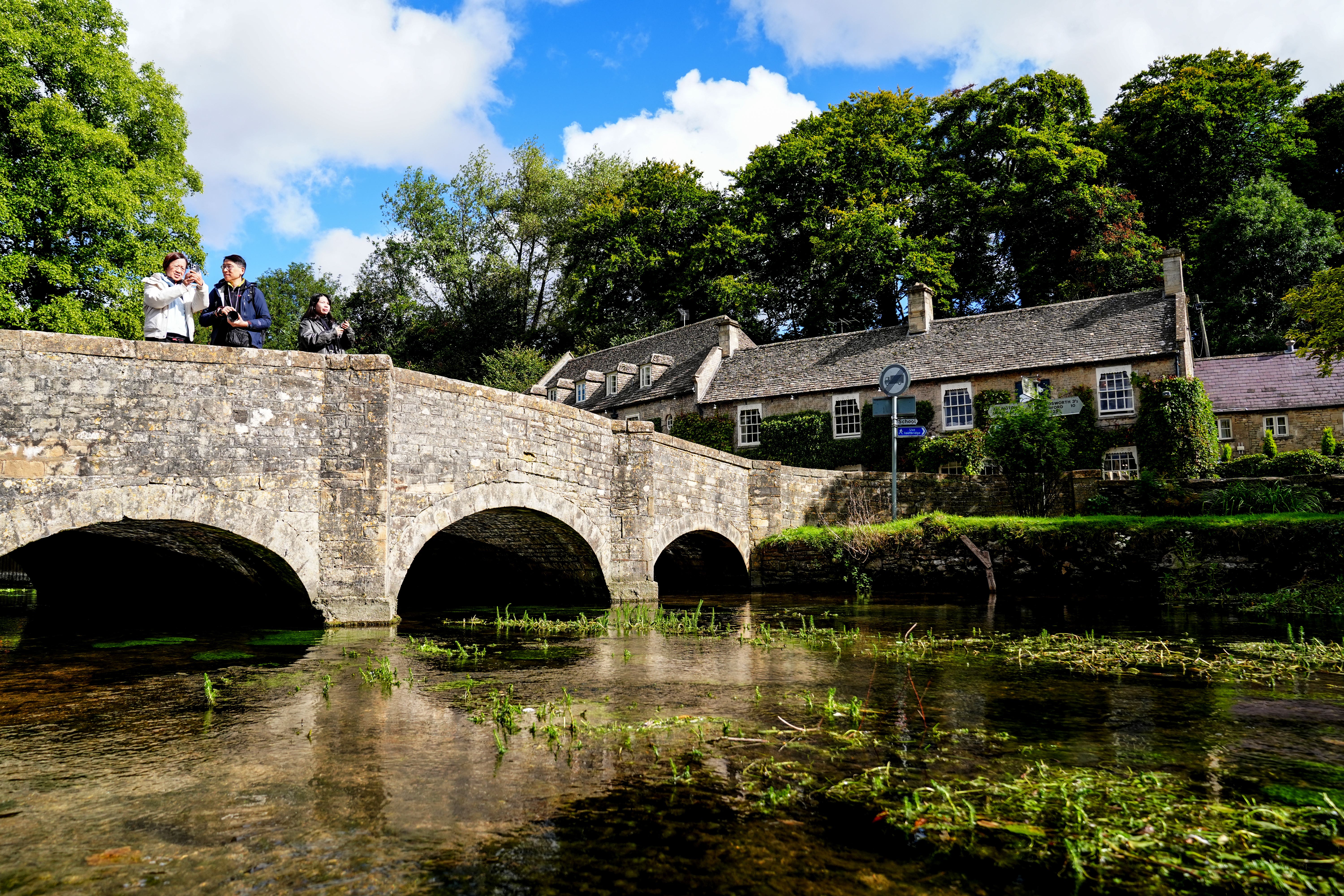 Tourists near the Swan Inn at Bibury