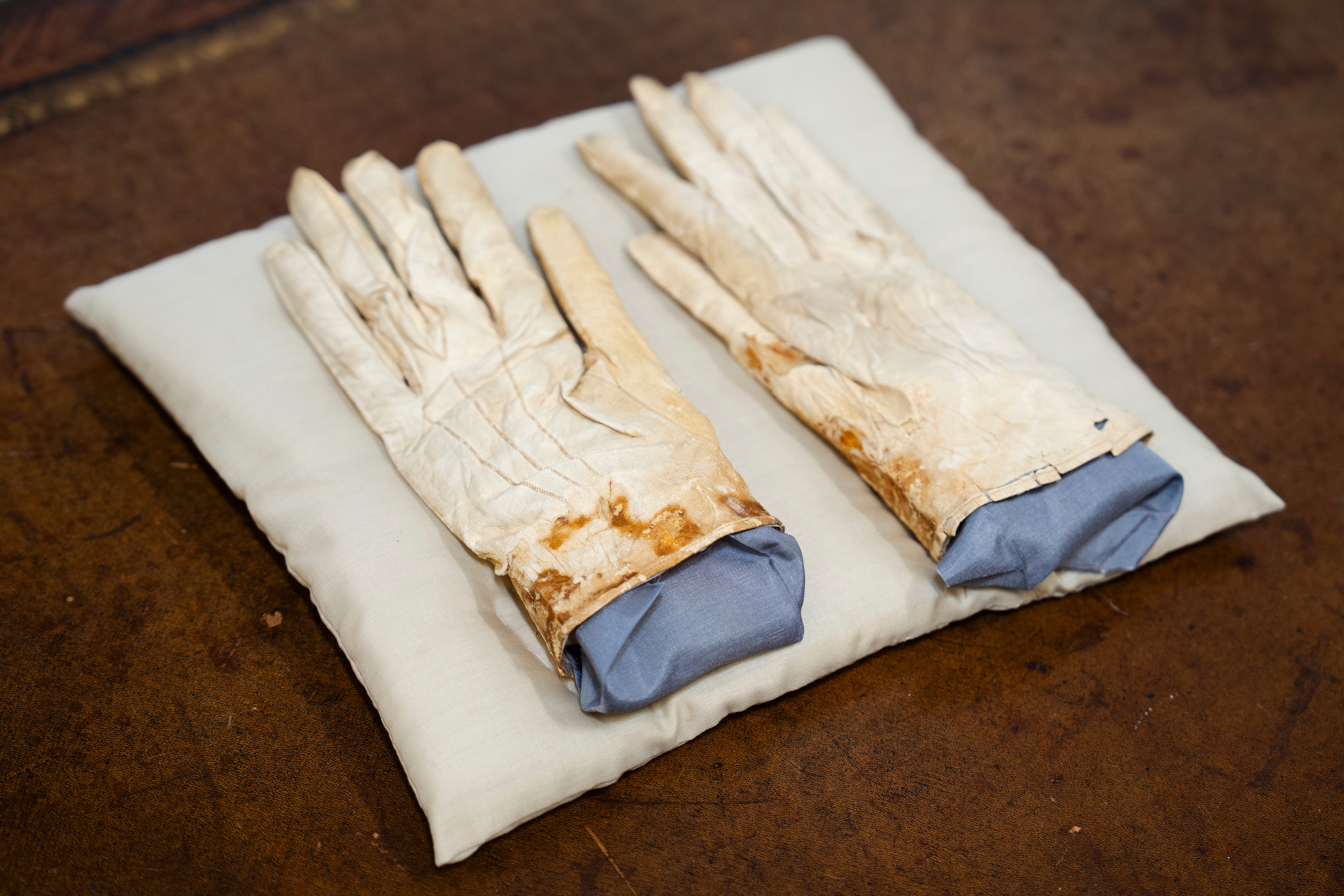 A Chicago auction house will sell some of President Abraham Lincoln’s belongings, including blood-stained gloves he had in his pocket the night he was killed.