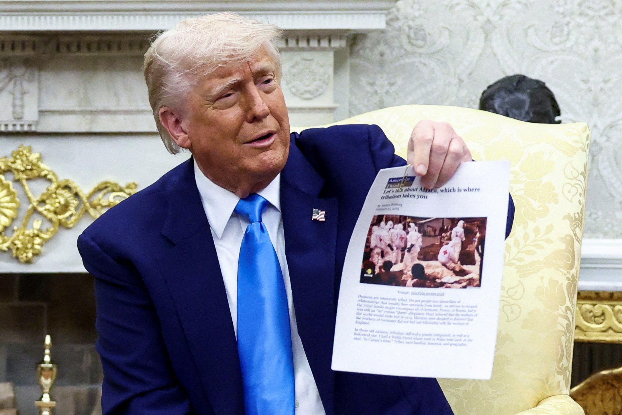 Trump shows off a printout of a blog that he claimed showed body bags of white farmers in South Africa. The image is actually of victims in a Congolese city after a jailbreak