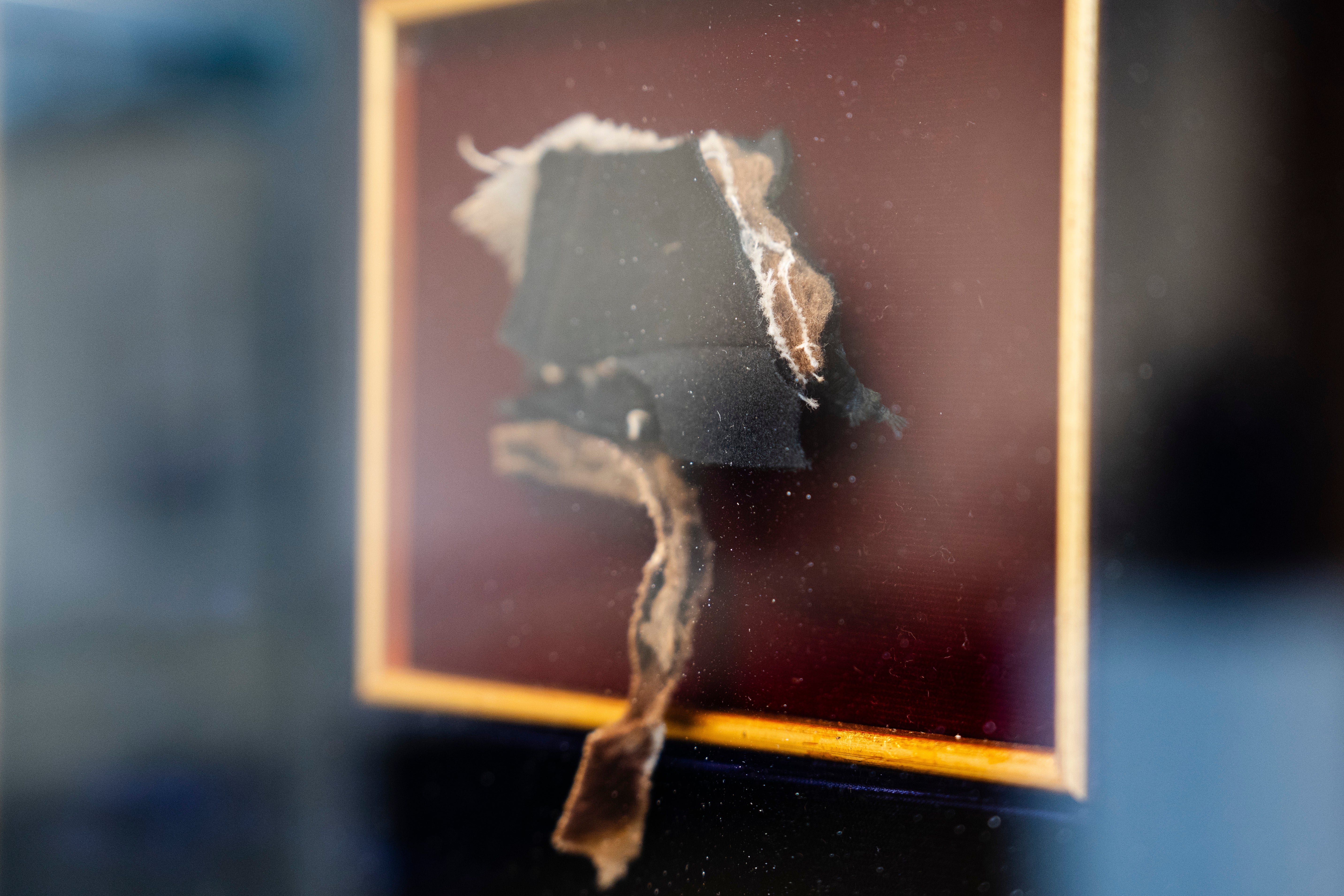 A piece of Abraham Lincoln’s coat, which he wore when he was assassinated at Ford's Theatre on April 14, 1865, is framed at Freeman's-Hindman in West Loop, Chicago, May 15, 2025 (Pat Nabong/Chicago Sun-Times via AP)