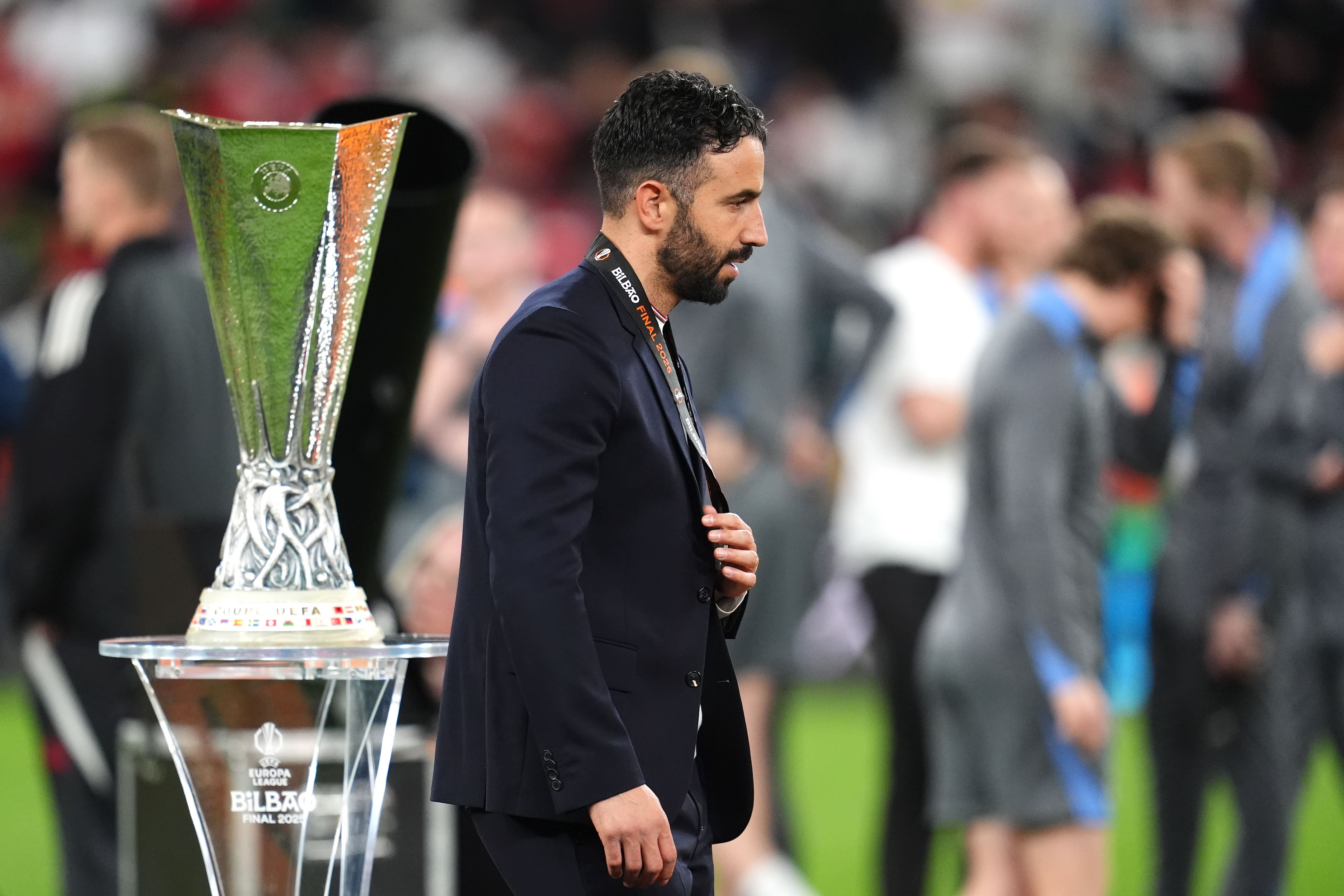 Manchester United manager Ruben Amorim walks past the Europa League trophy (Adam Davy/PA)