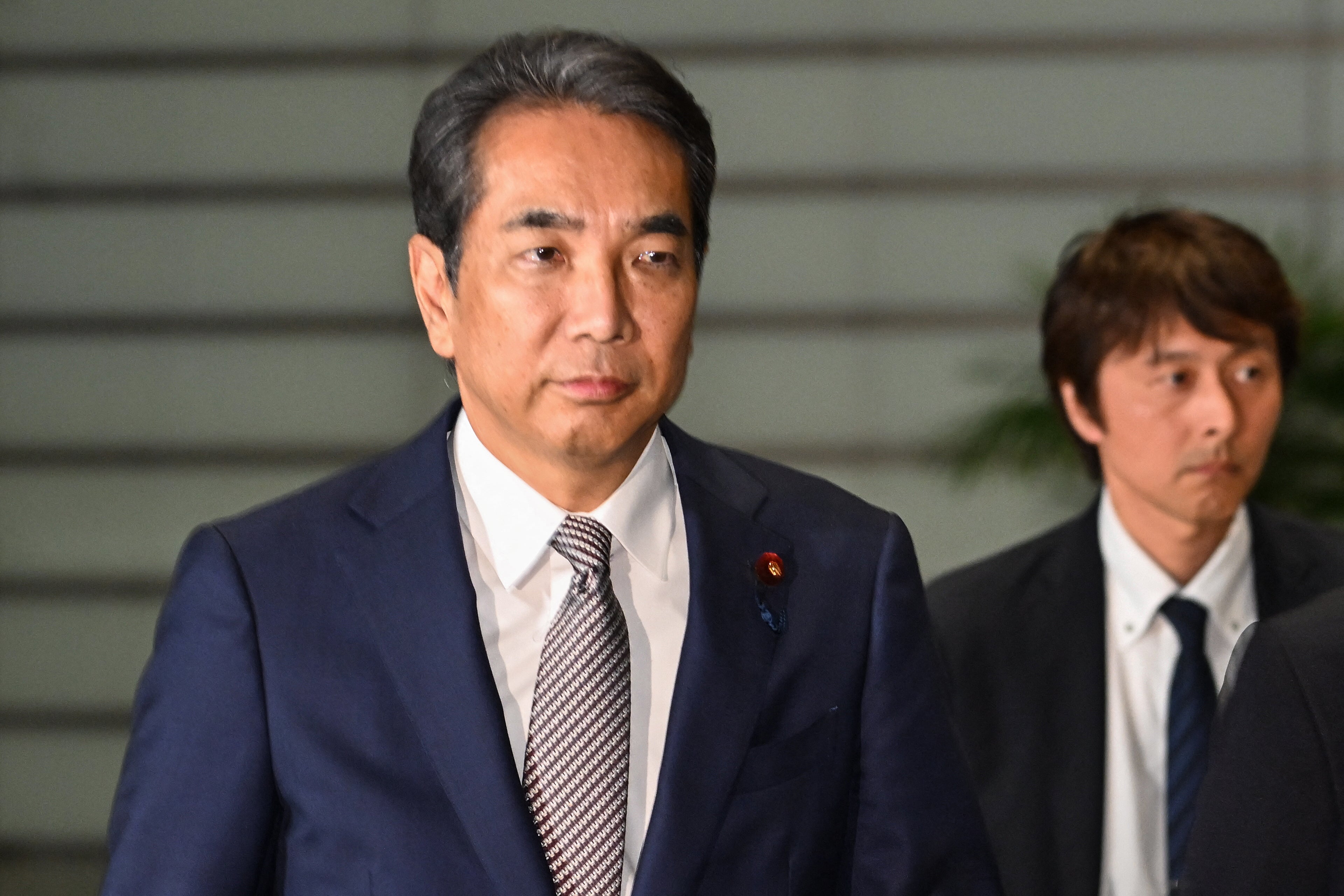 Japan's Agriculture Minister Taku Eto (L) has stepped down