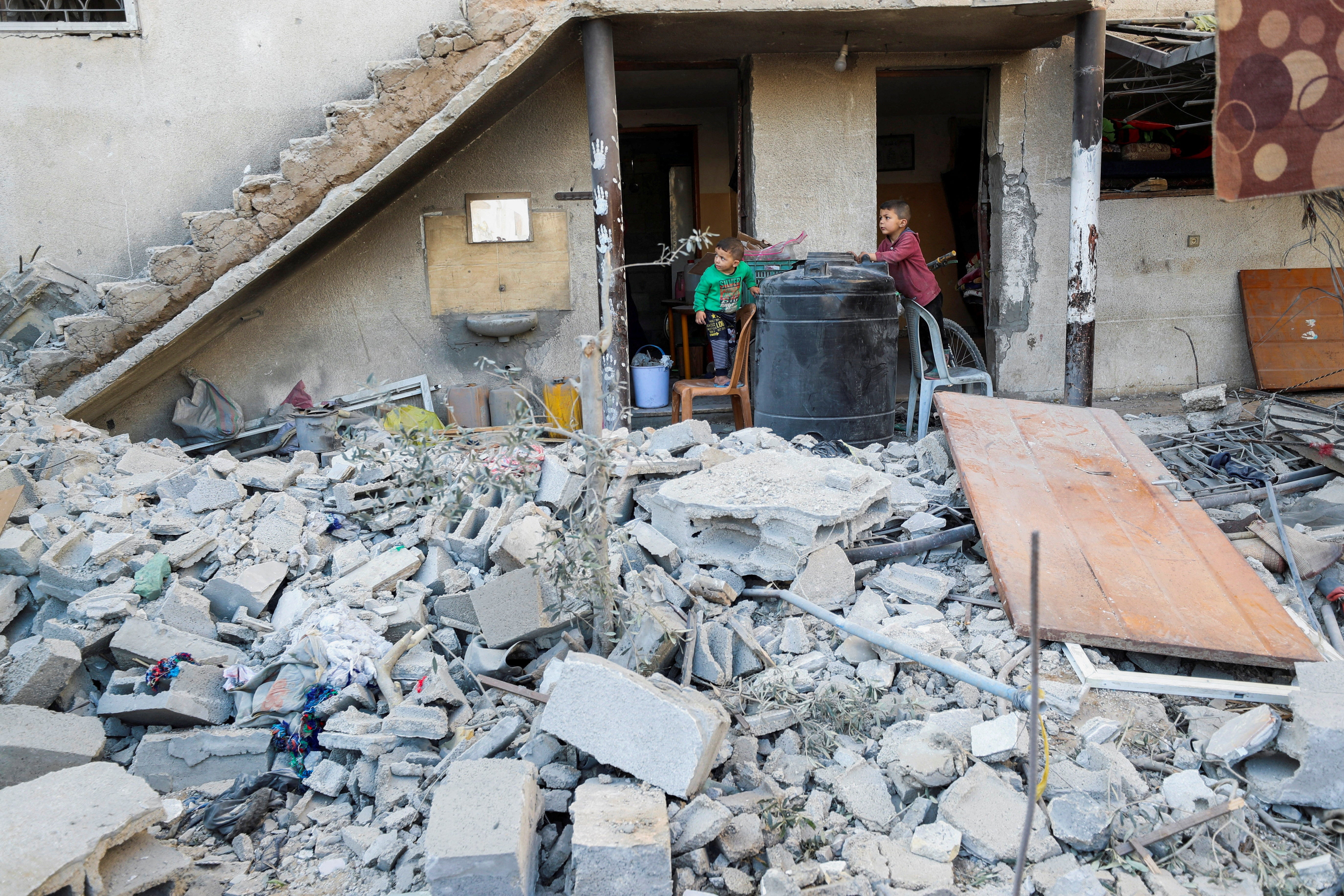 Palestinian boys look on at the site of an Israeli strike on a house in Jabalia, northern Gaza Strip on Wednesday