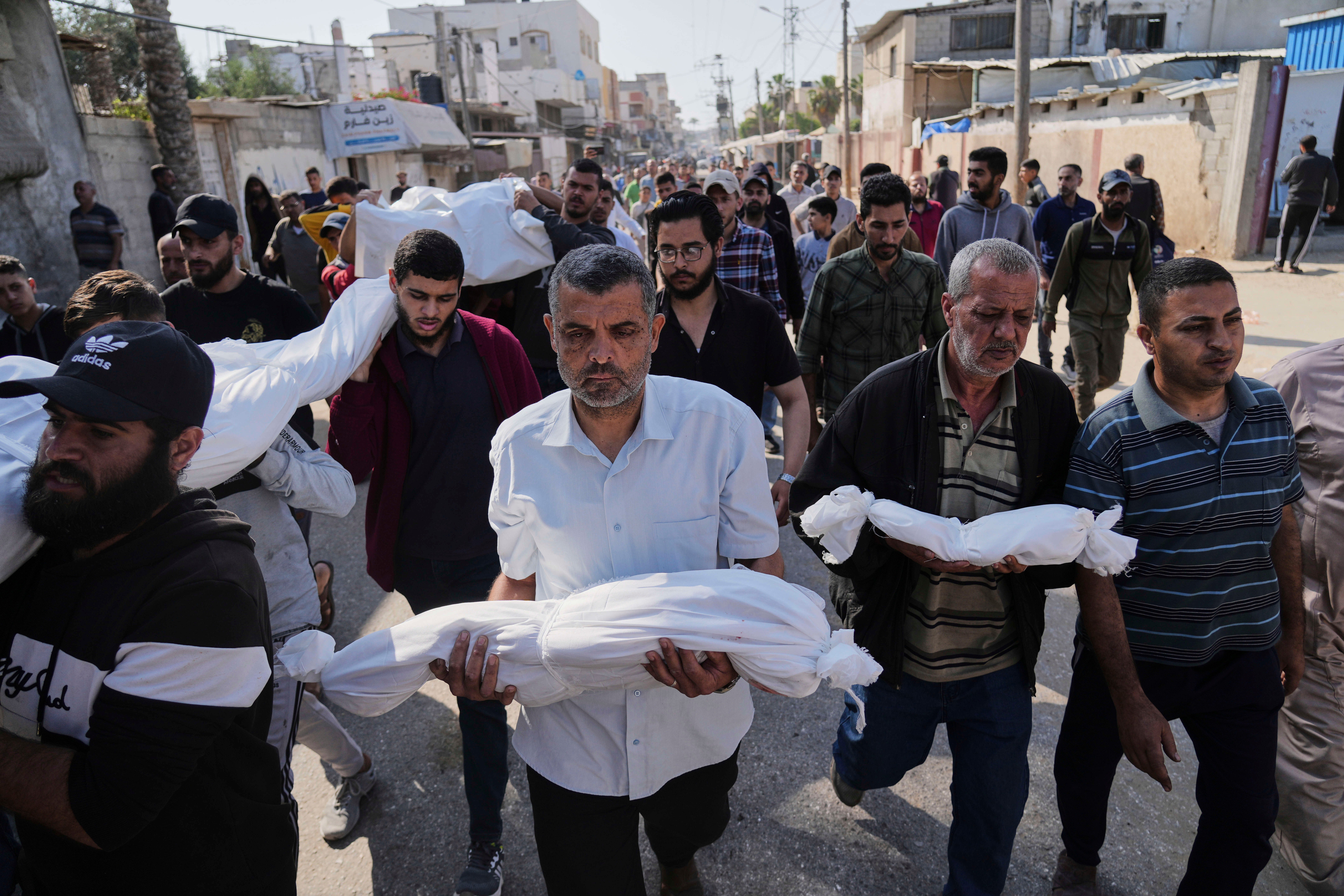 Palestinians carry the bodies of their relatives killed in an Israeli airstrike in Deir al-Balah, Gaza