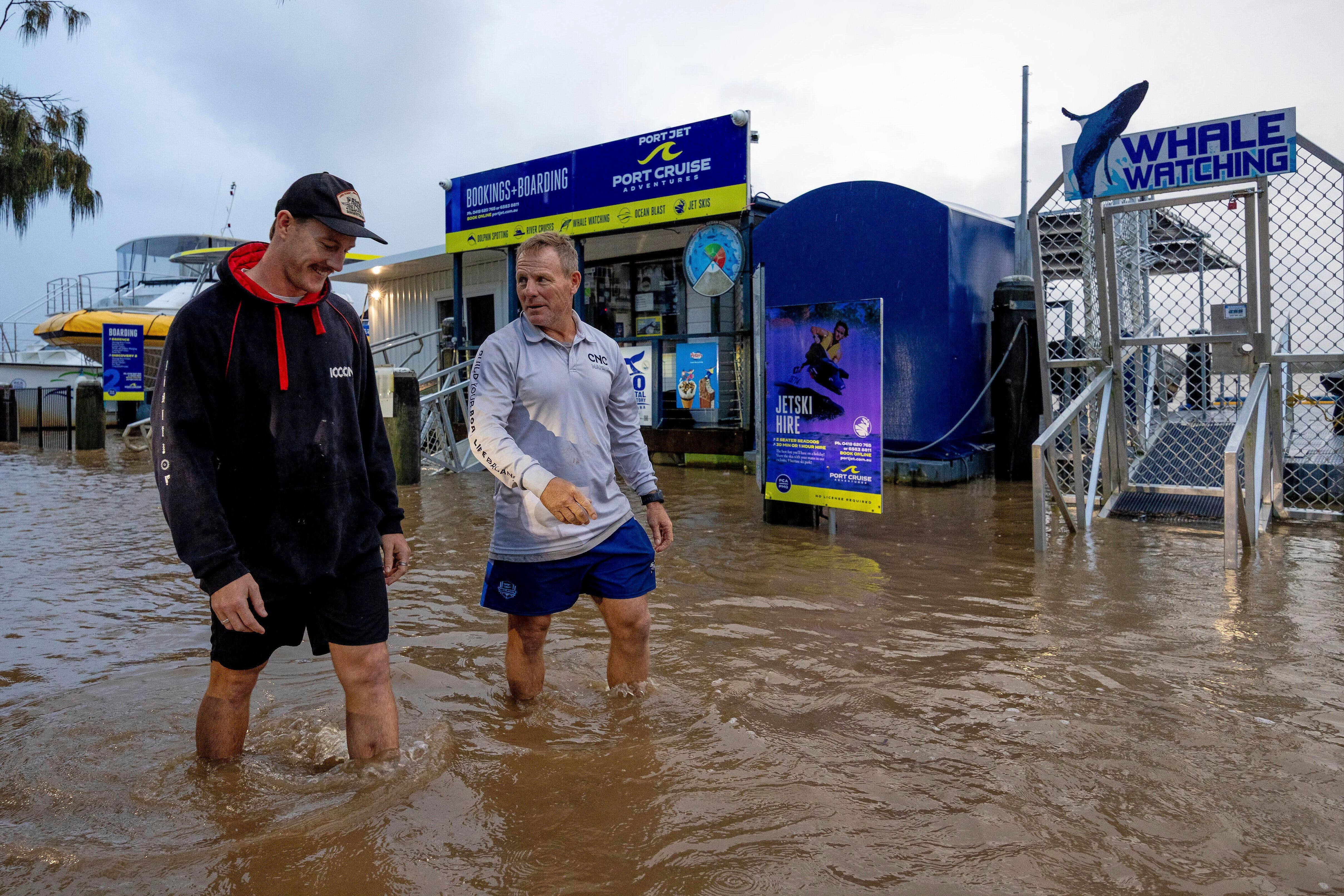 Conor Lang and Anthony Heeney walk through flooded areas in Port Macquarie, north of Sydney, Australia, Wednesday, May 21, 2025