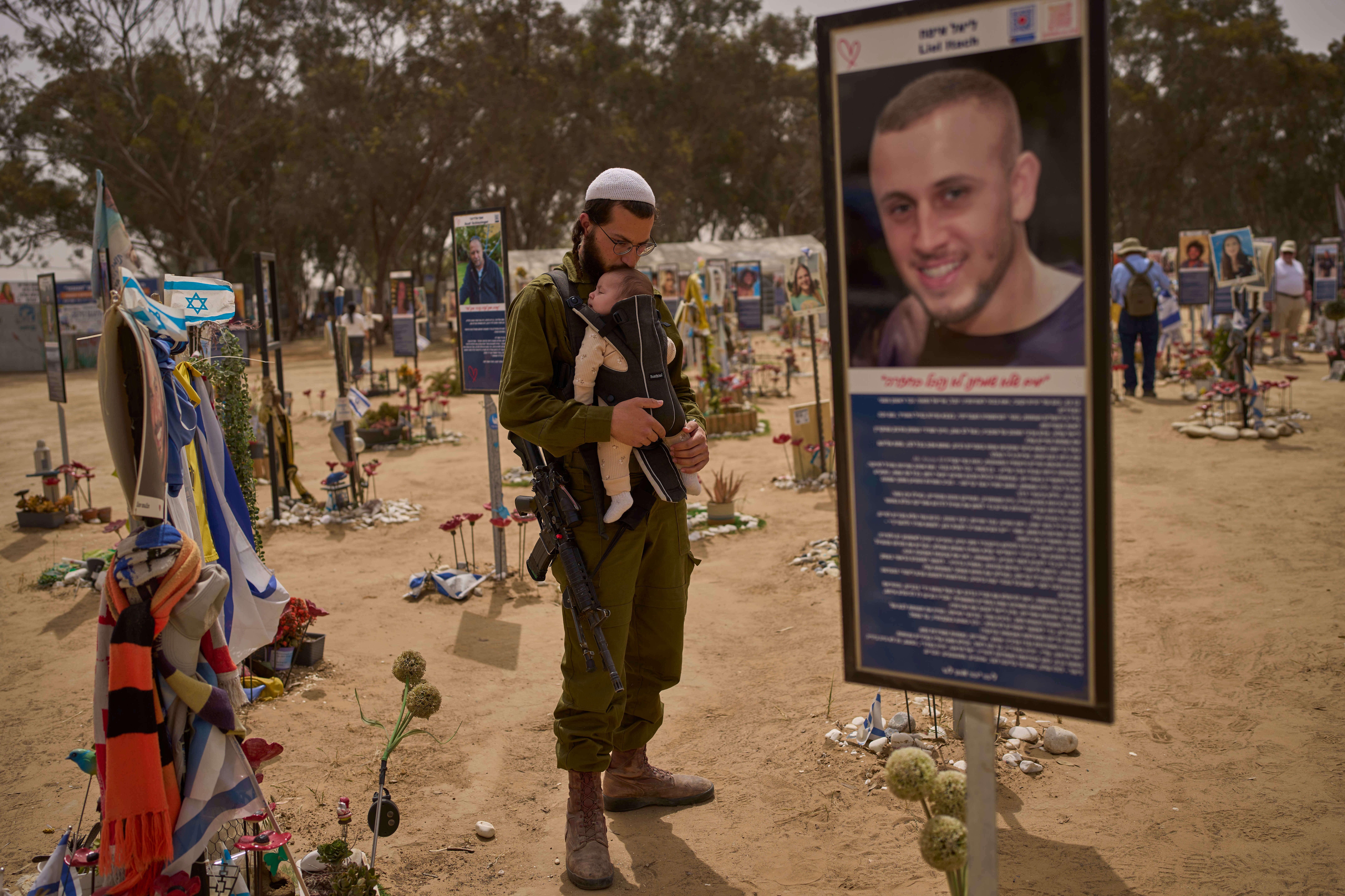 An Israeli soldier walks at the site of the 7 October, 2023 attack by Hamas militants on the Nova music festival