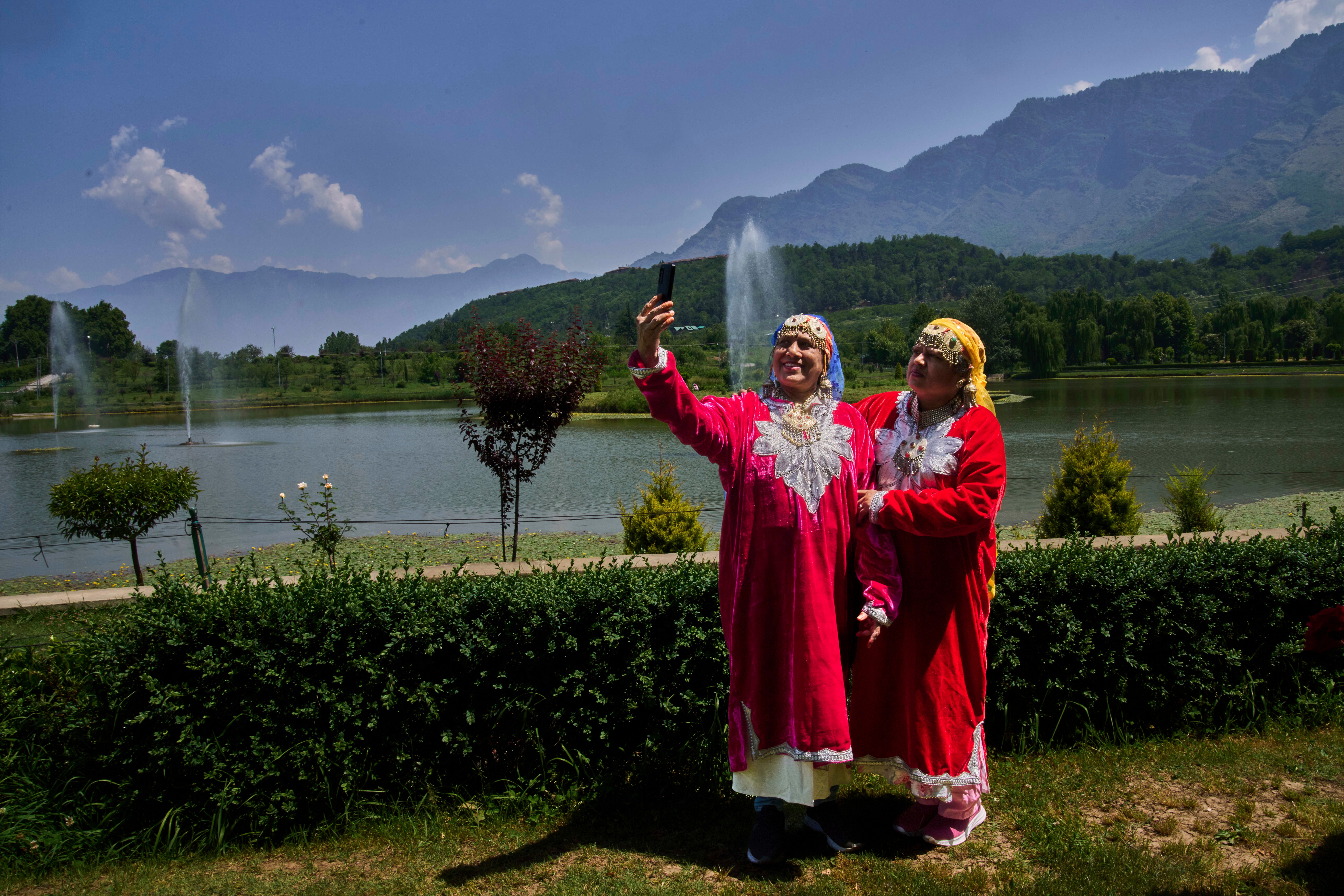 Surekha Dube, left, and Sunita Kamble, tourists from the Indian state of Maharashtra, take a selfie inside a deserted garden in Srinagar, Indian controlled Kashmir, India, Tuesday, May 20, 2025