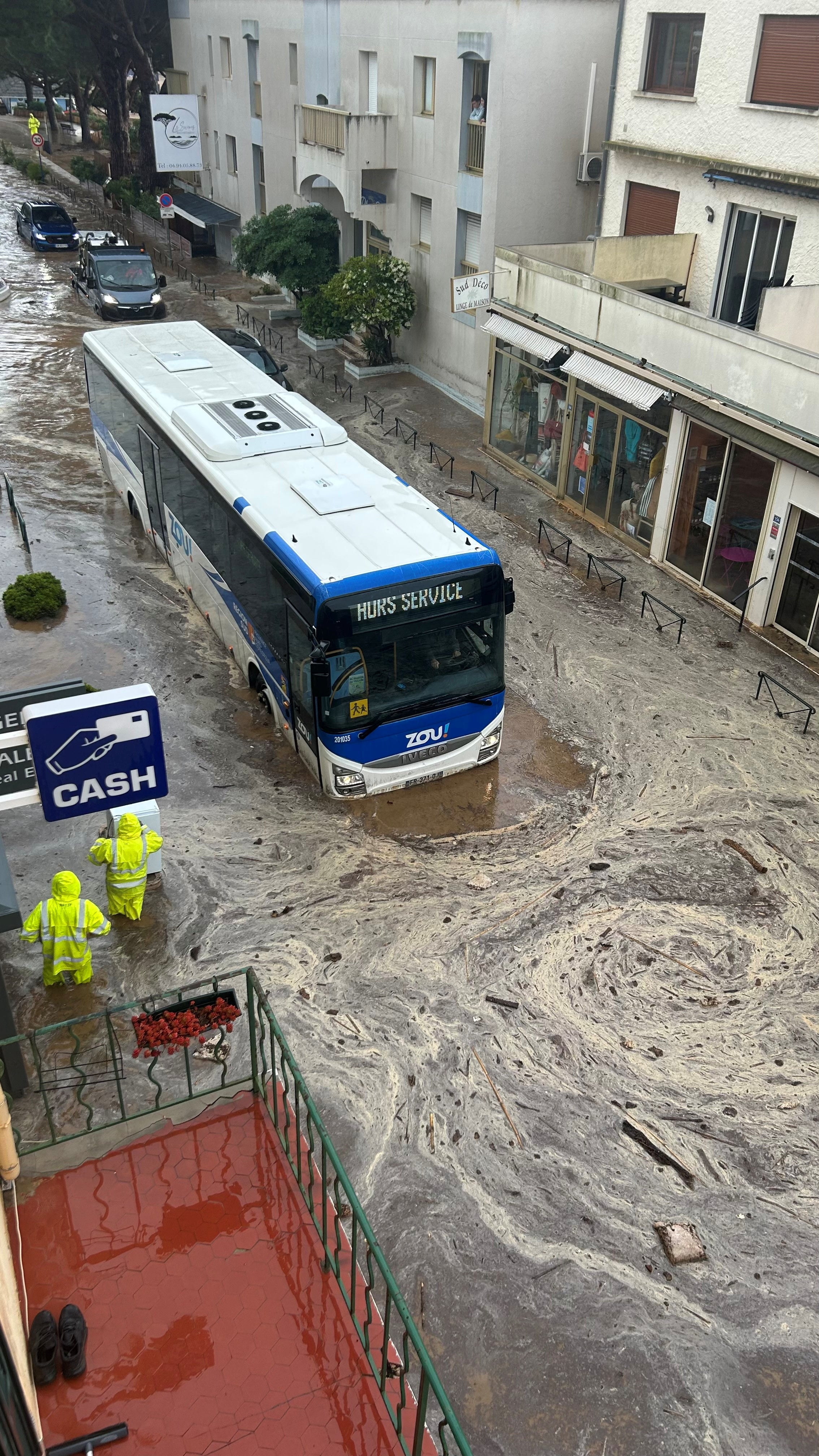 A bus is partially submerged in floodwaters, following heavy rainfall, in Le Lavandou