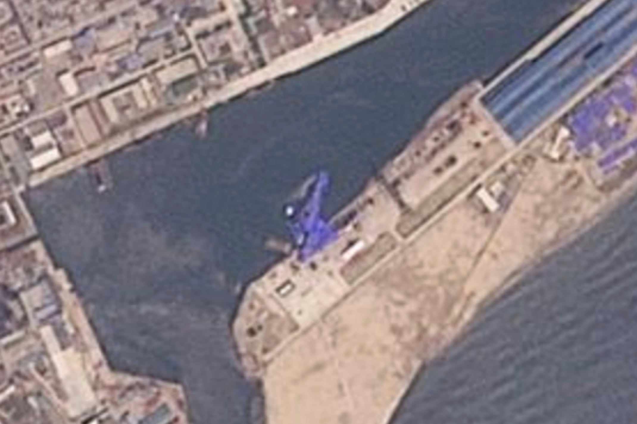 Satellite image from Planet Labs PBC shows a blue tarp covering a North Korean destroyer after it suffered a failed launch