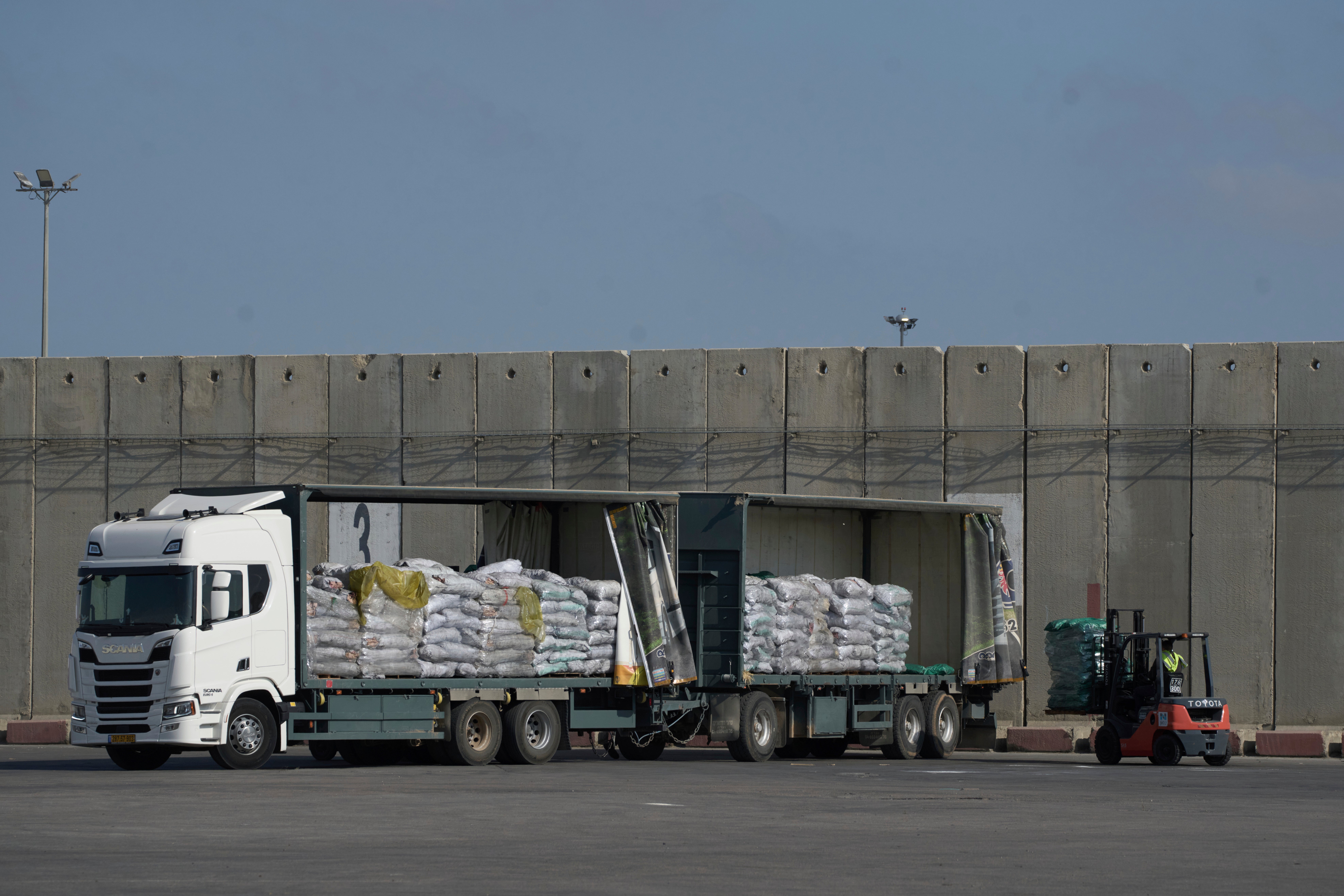 About 200 aid trucks have entered Gaza, but only about 90 have been offloaded, while others face delays at the Kerem Shalom Crossing