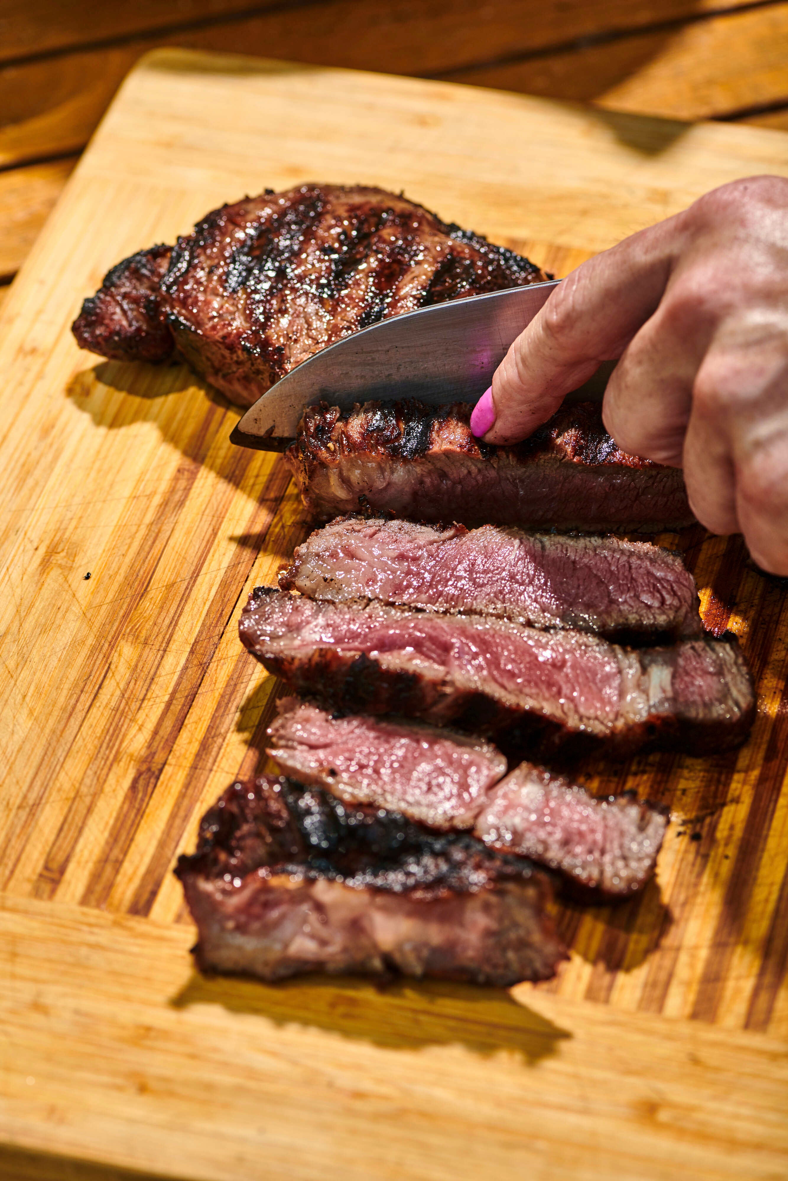 A grilled steak being sliced