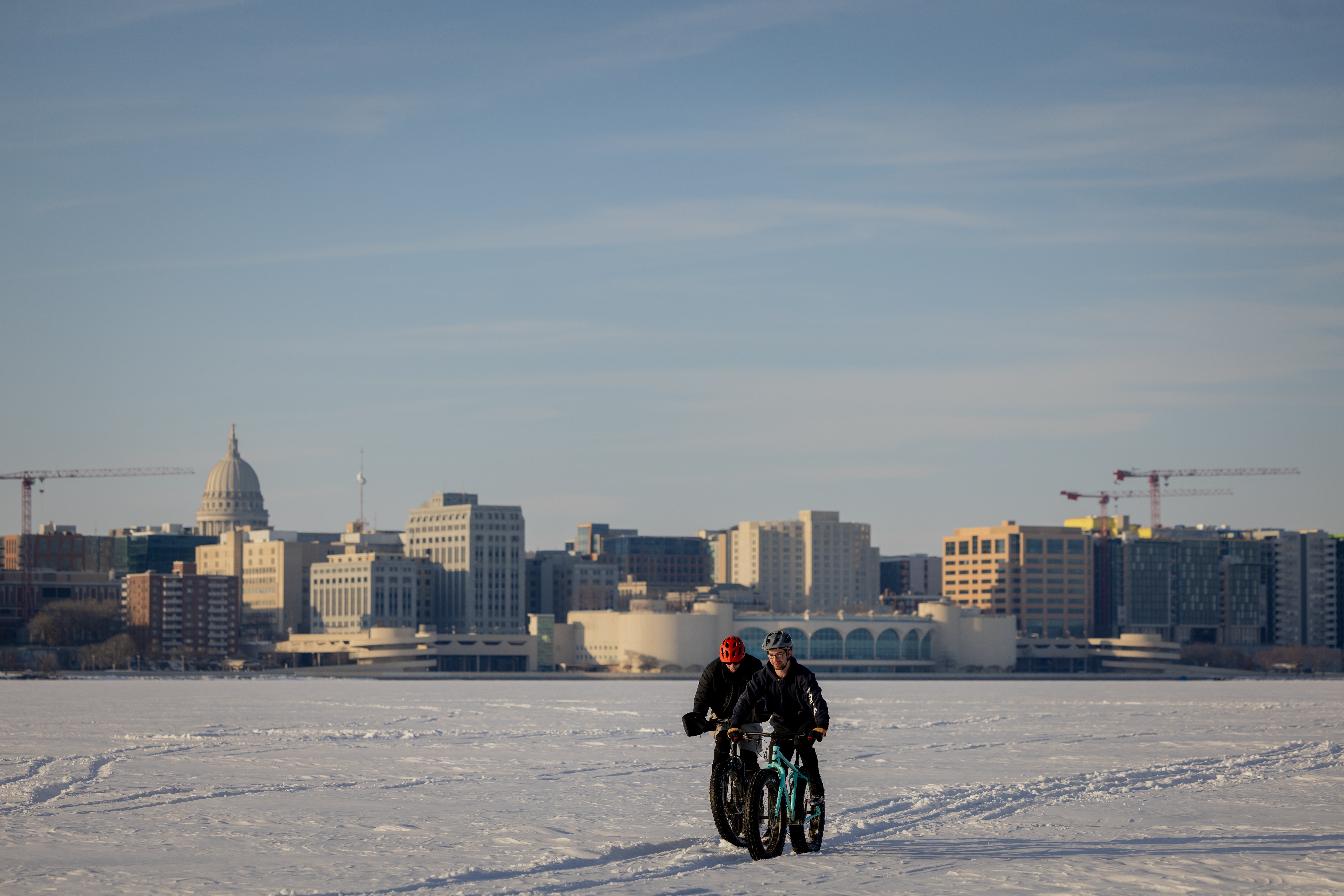 Freezing weather never stops cyclists in Madison. Two are pictured here fat-tire biking across a frozen Lake Monona