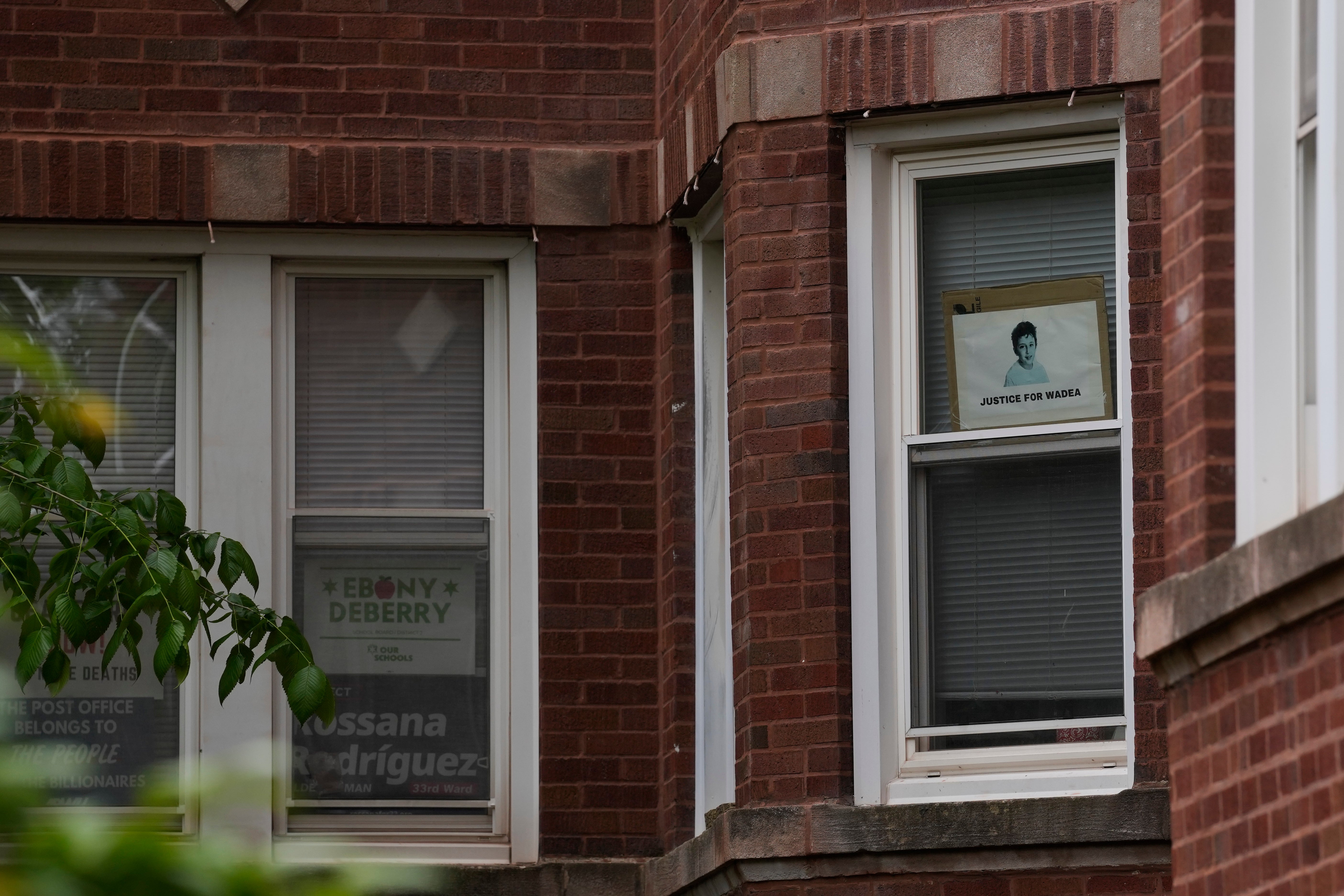 Signs are seen in the window of a building listed in public records as the home of Rodriguez, including one that reads 'Justice for Wadea,' a reference to the six-year-old Palestinian American boy killed in Chicago two years ago.