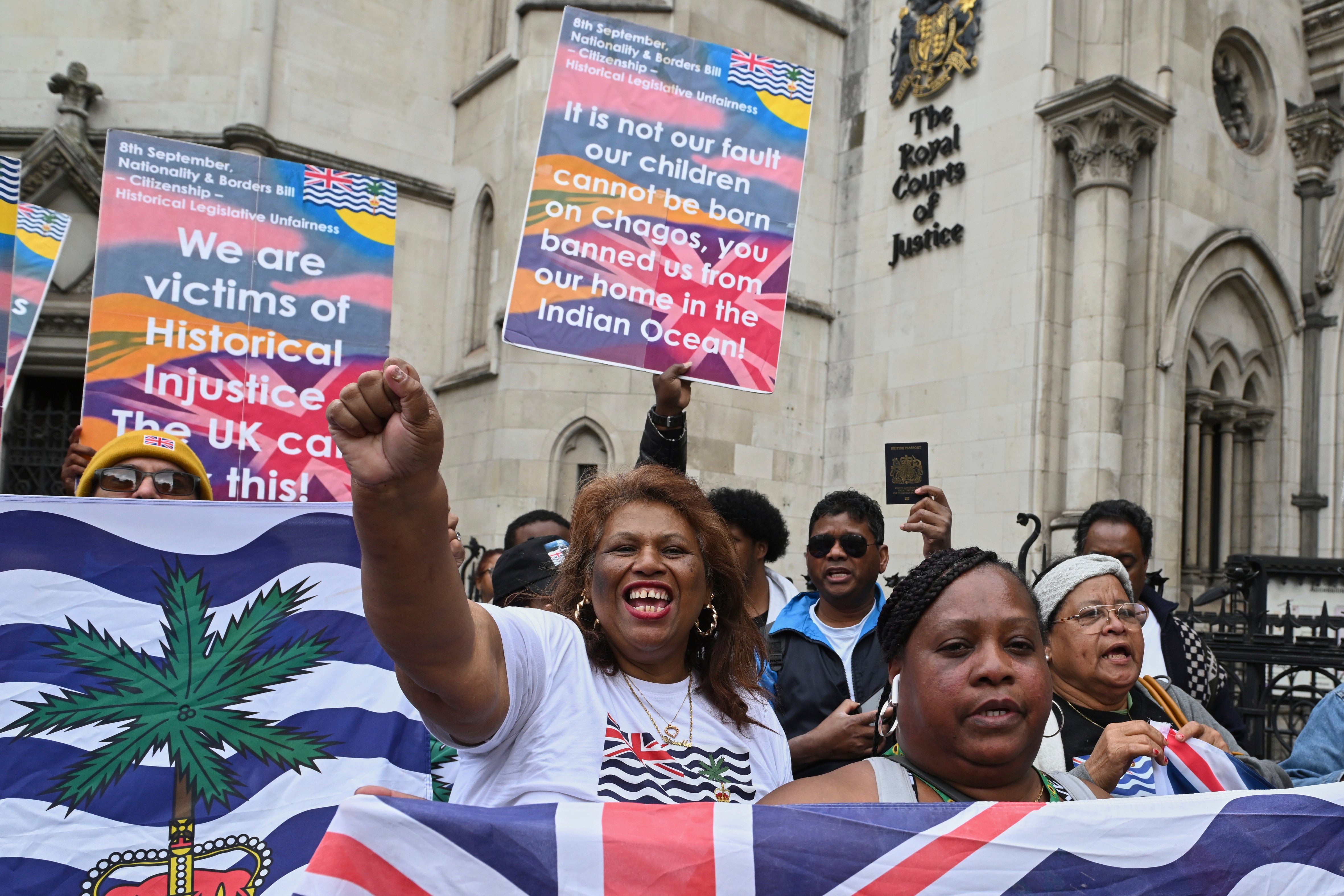 People demonstrate outside the High Court in London, Thursday, May 22, 2025, after a British court blocked the U.K. from transferring sovereignty over the Chagos Islands to Mauritius hours before the agreement was due to be signed. (AP Photo/Thomas Krych)