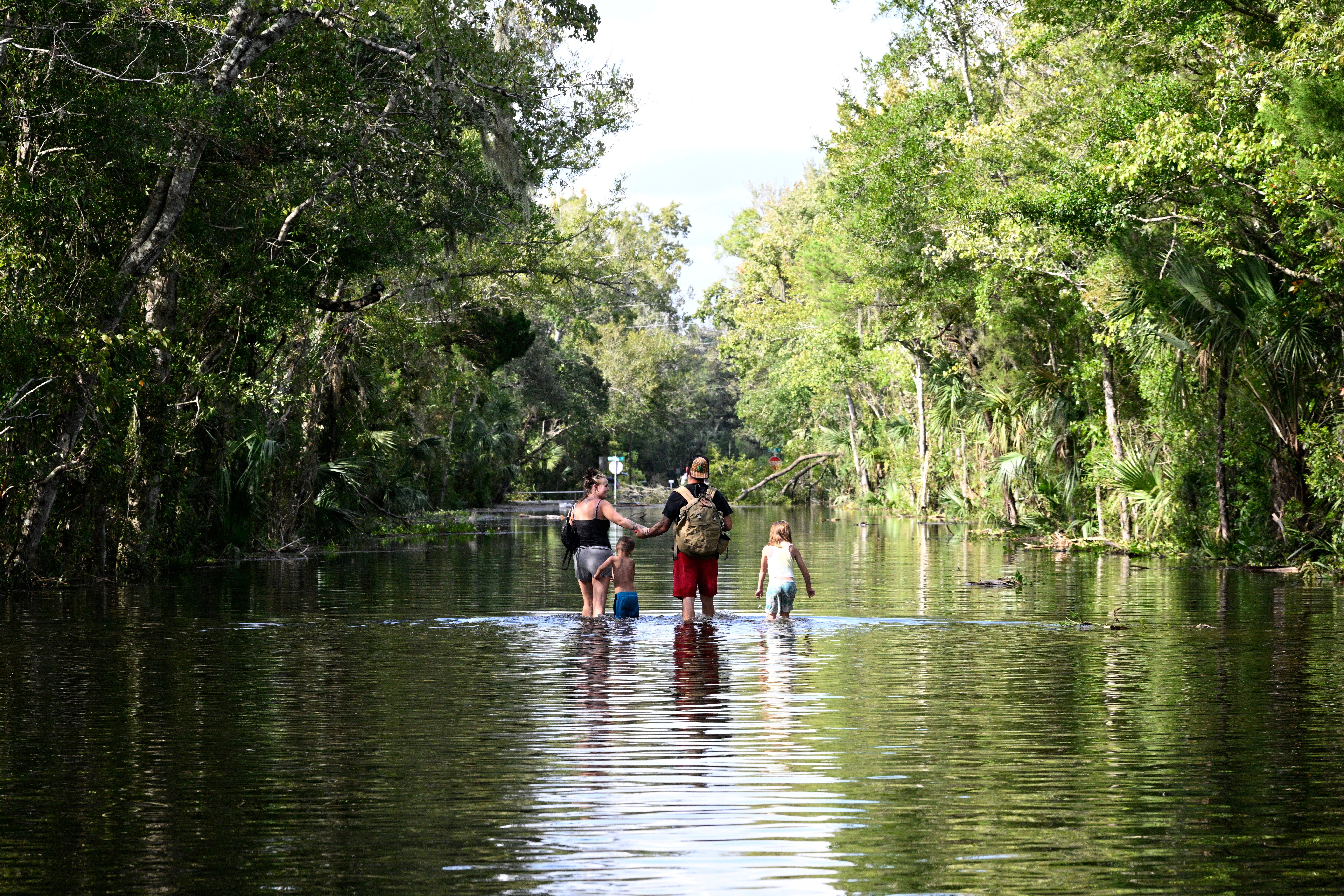 People navigate through debris after a hurricane in North Carolina. FEMA chief recently questioned about America having a hurricane season, but officials downplayed it as a joke.