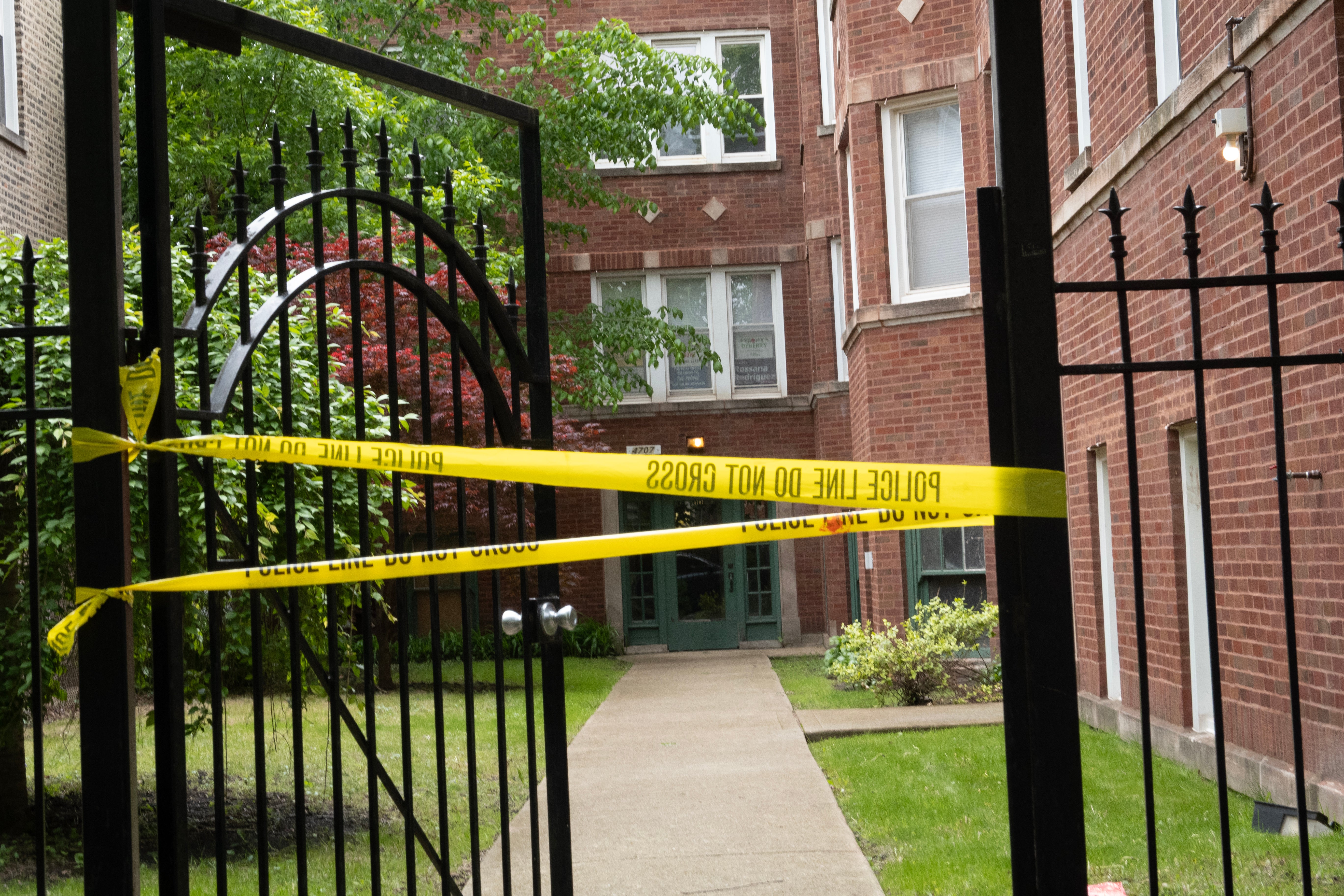 Crime scene tape is stretched across the front of a building where shooting suspect Elias Rodriguez lived while law enforcement officials from the FBI, Joint Terrorism Task Force, and Chicago Police participate in a search of his residence on May 22.