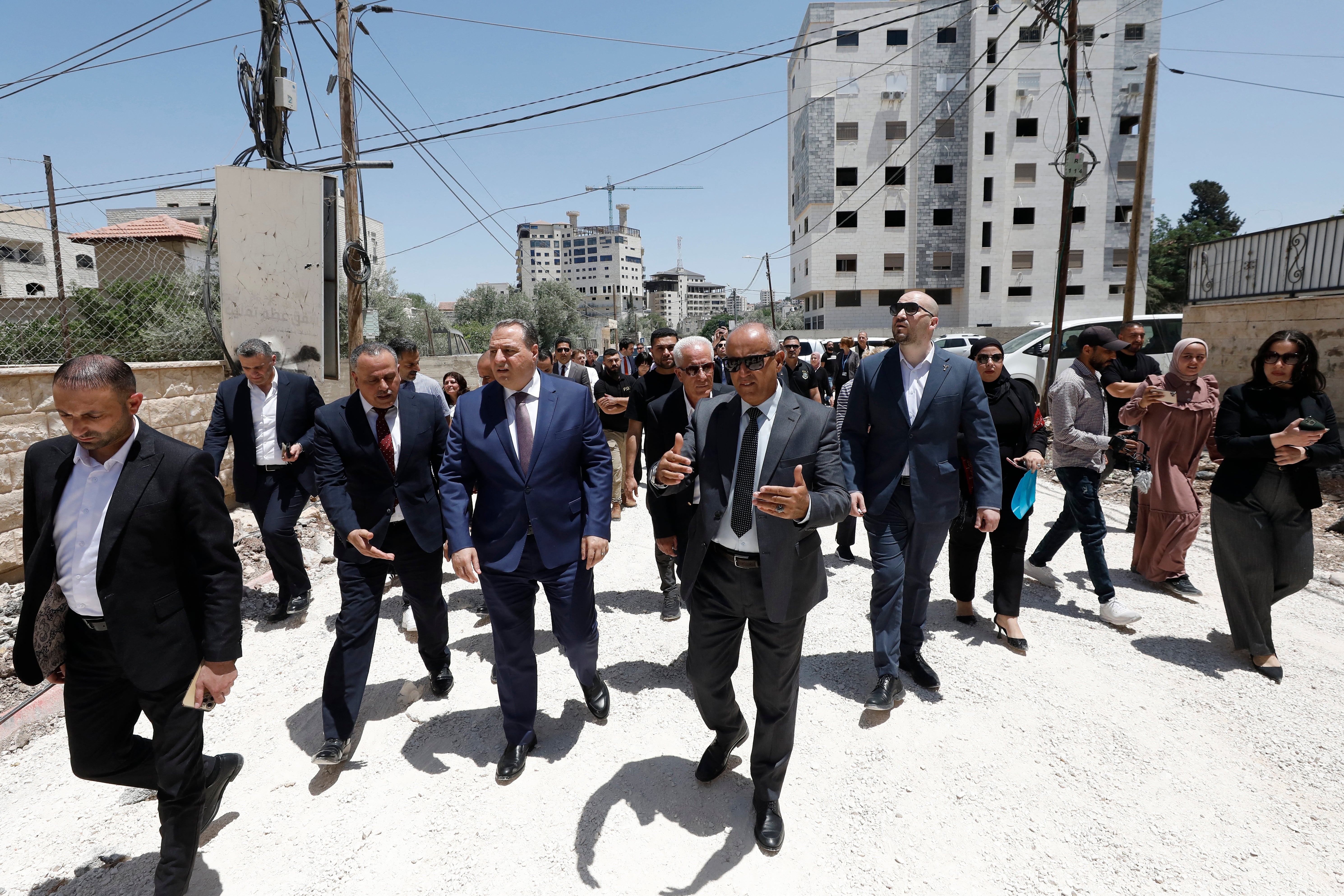 Members of a diplomatic delegation from the European Union walk near the eastern entrance of Jenin camp