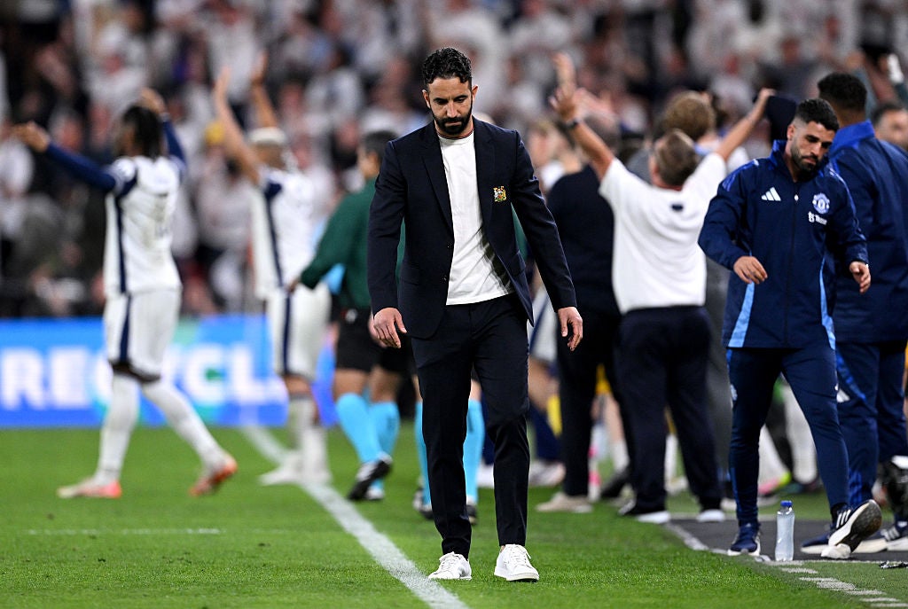 Amorim looks downcast as Tottenham players celebrate in the background