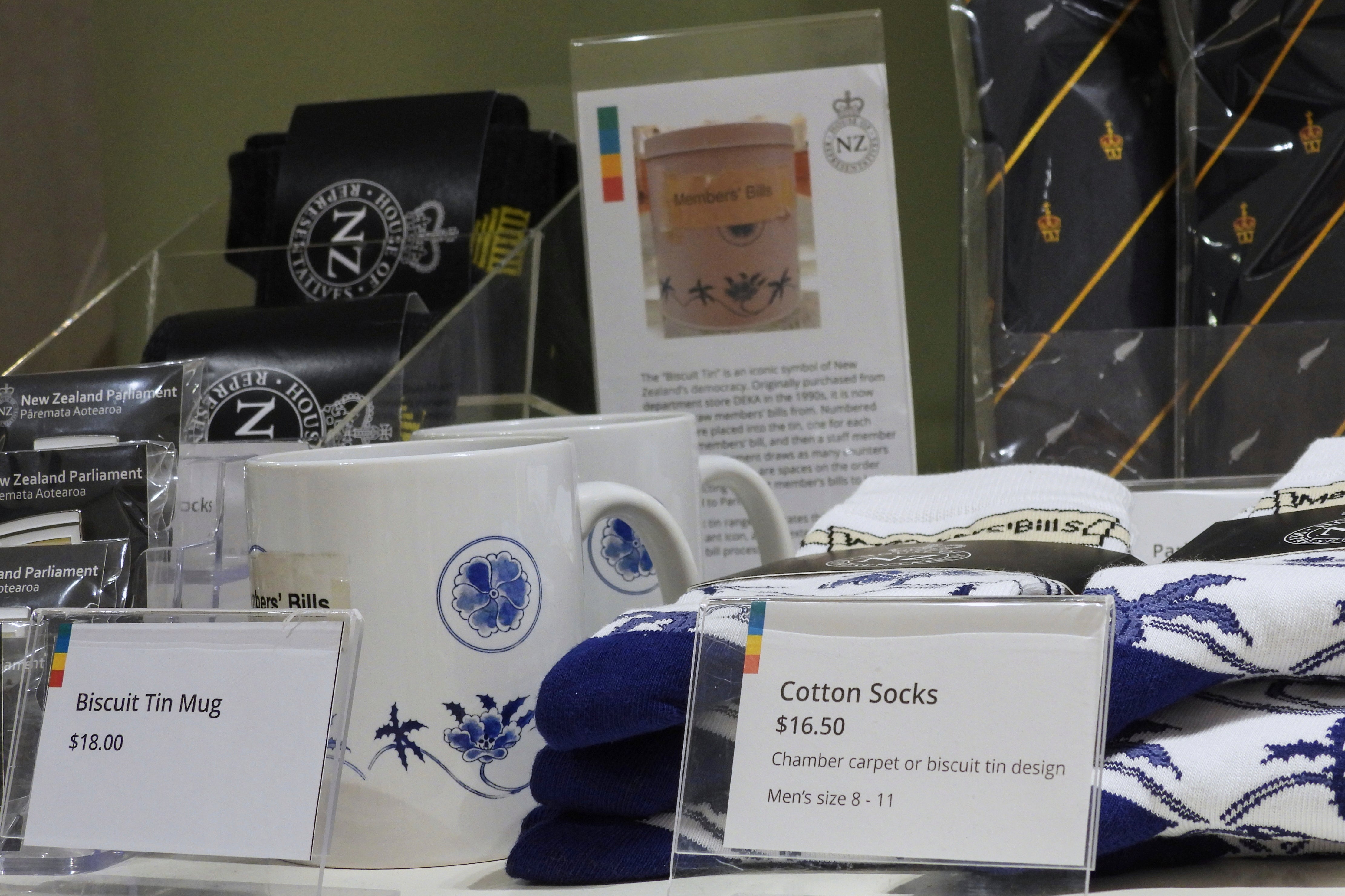 Socks are mugs printed with the biscuit tin pattern and label are seen for sale in the New Zealand Parliament gift shop