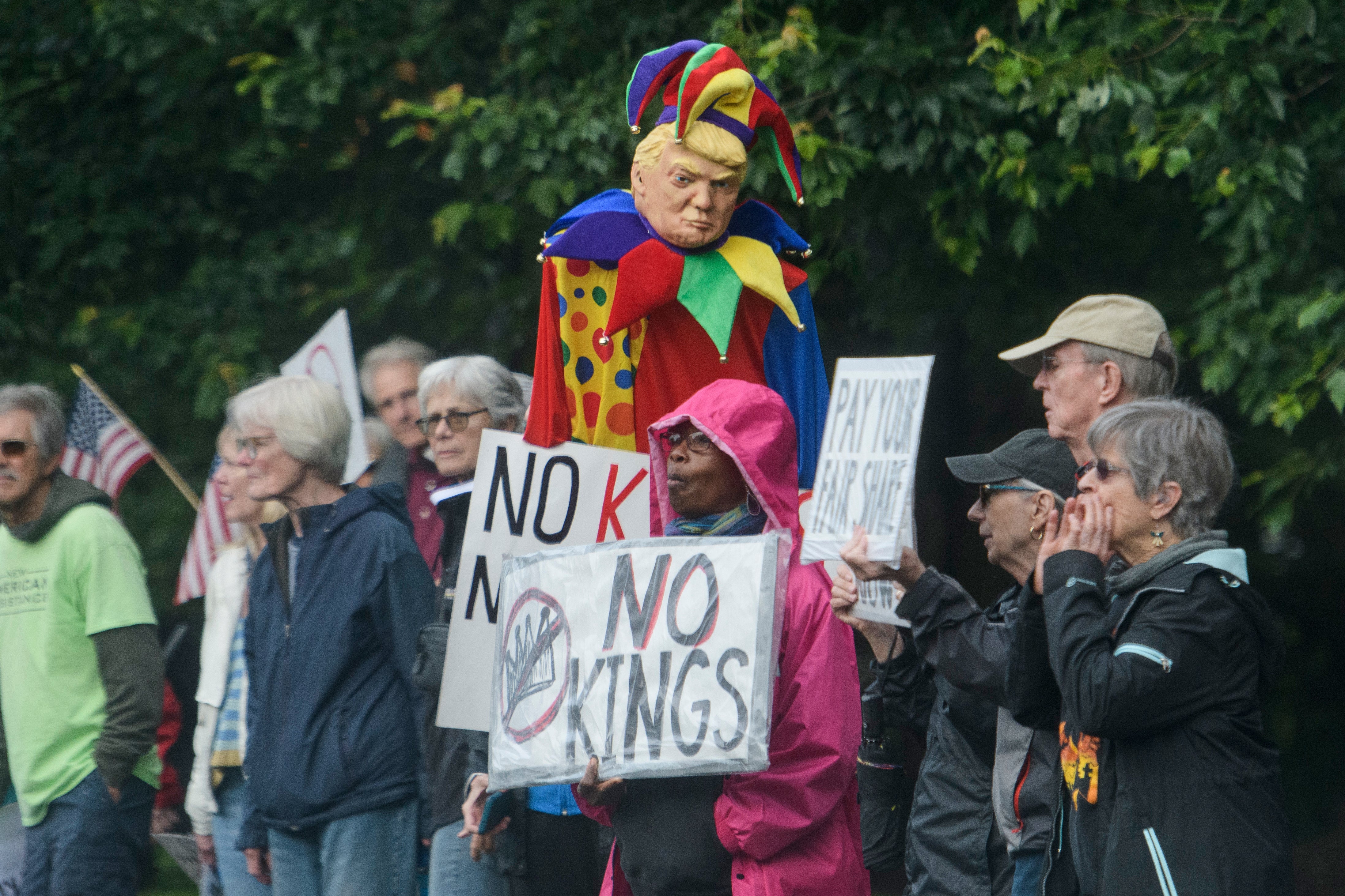Demonstrators protest near Trump National Golf Club Washington DC before the arrival of President Donald Trump in Sterling, Virginia