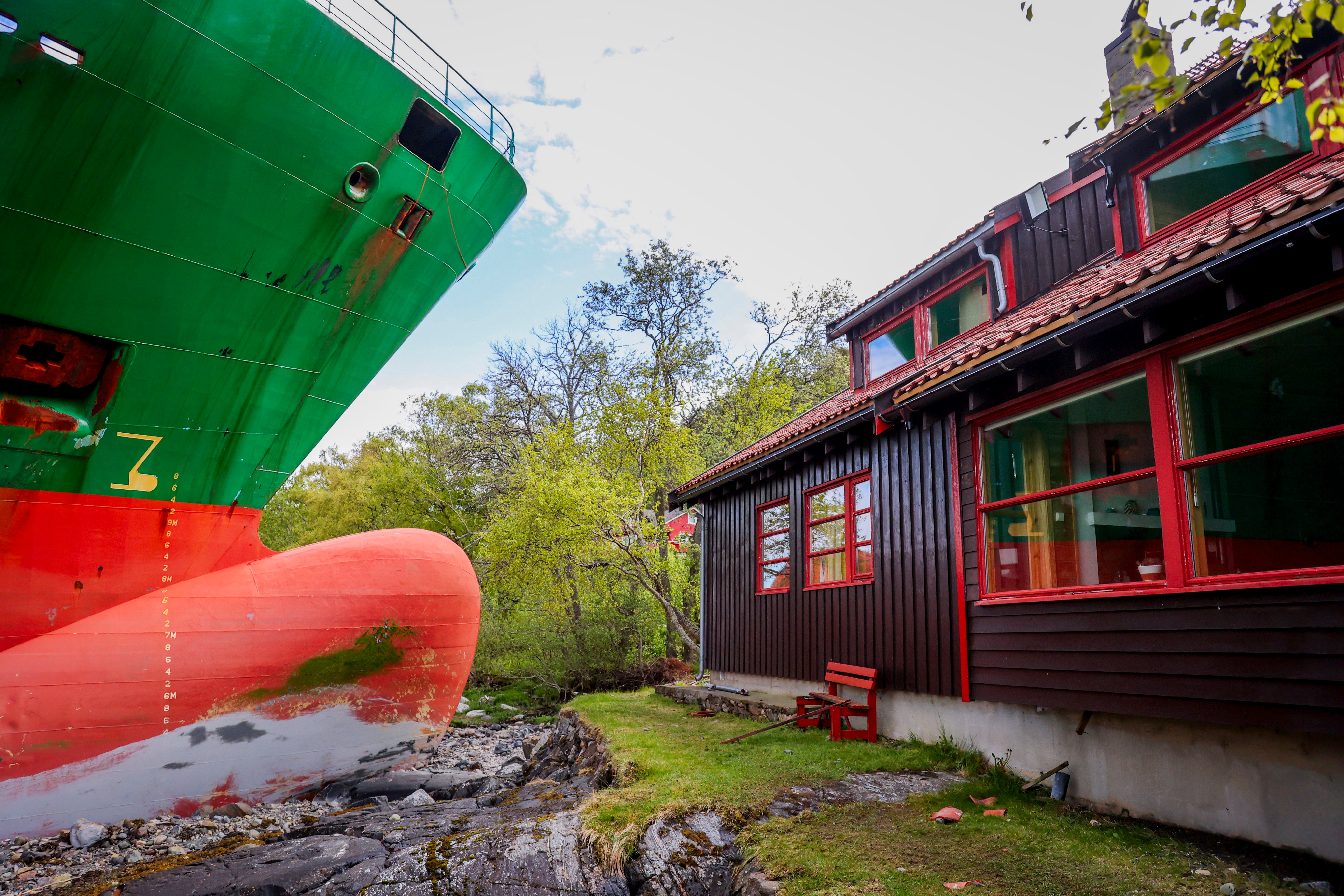 The container ship NCL Salten is seen next to Johan Helberg's house, after the 135-meter-long ship ran aground almost hitting it, in the Trondheimsfjord outside Byneset, in Trondheim, Norway, Thursday May 22, 2025. (Jan Langhaug/NTB Scanpix via AP)