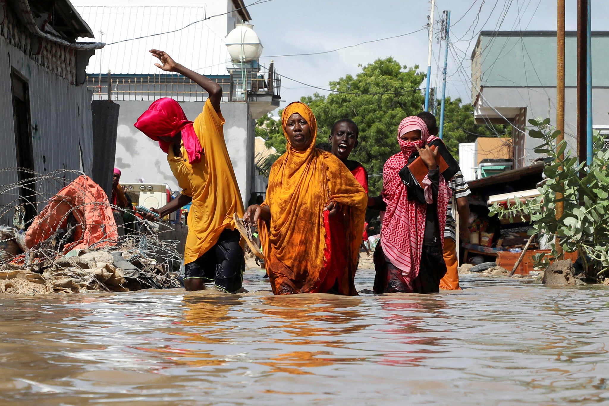 A Somali family wades through flood waters as they flee after overnight rains destroyed their home, in Wadajir district of Mogadishu, Somalia, earlier this month