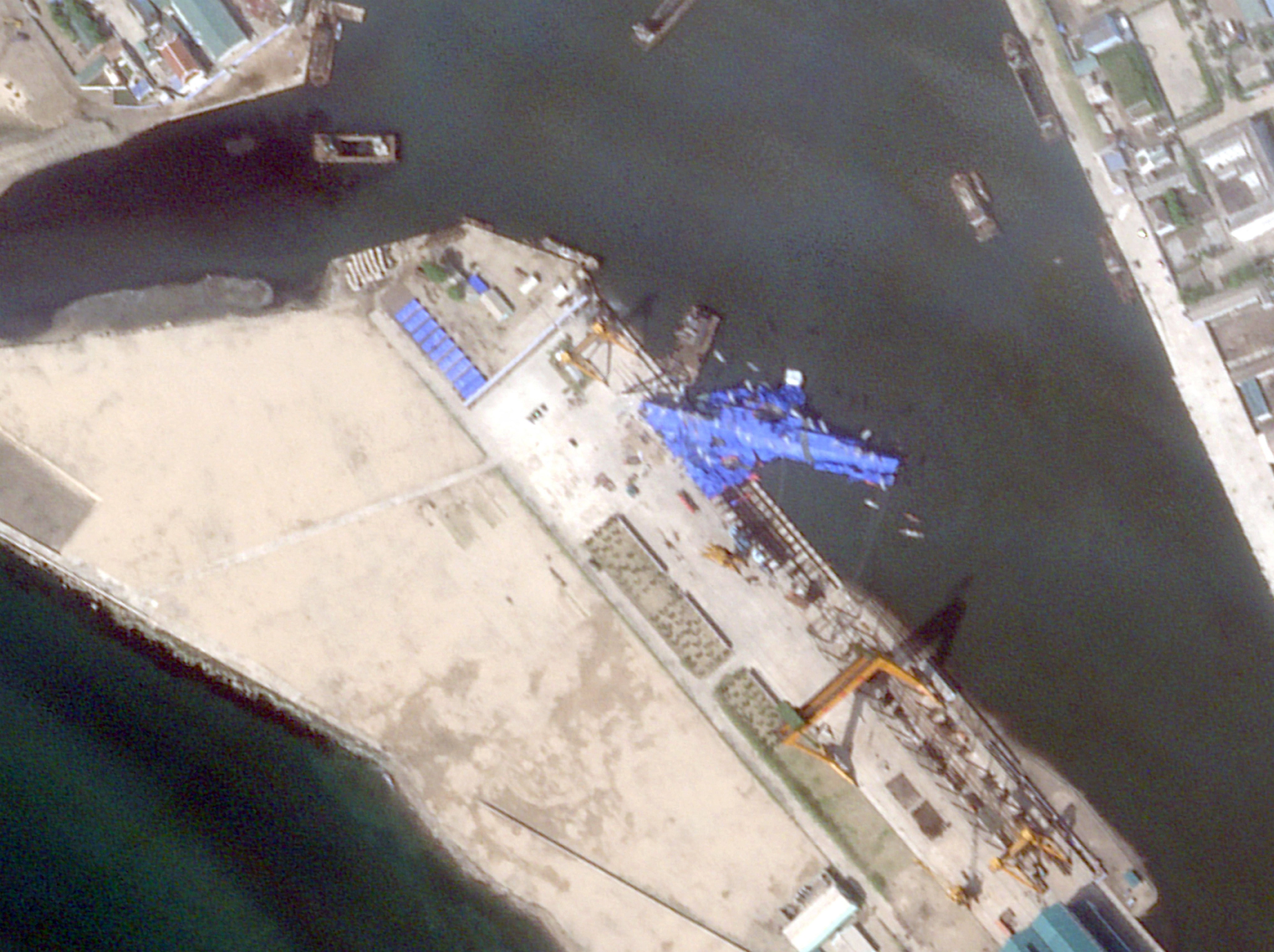 This satellite image taken and released on 23 May 2025 by Planet Labs PBC shows a new North Korean warship that appears to be capsized at the harbour after its launching ceremony in Chongjin