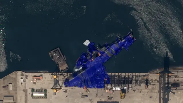 <p>Satellite images show North Korean warship laying on its side after botched launch</p>