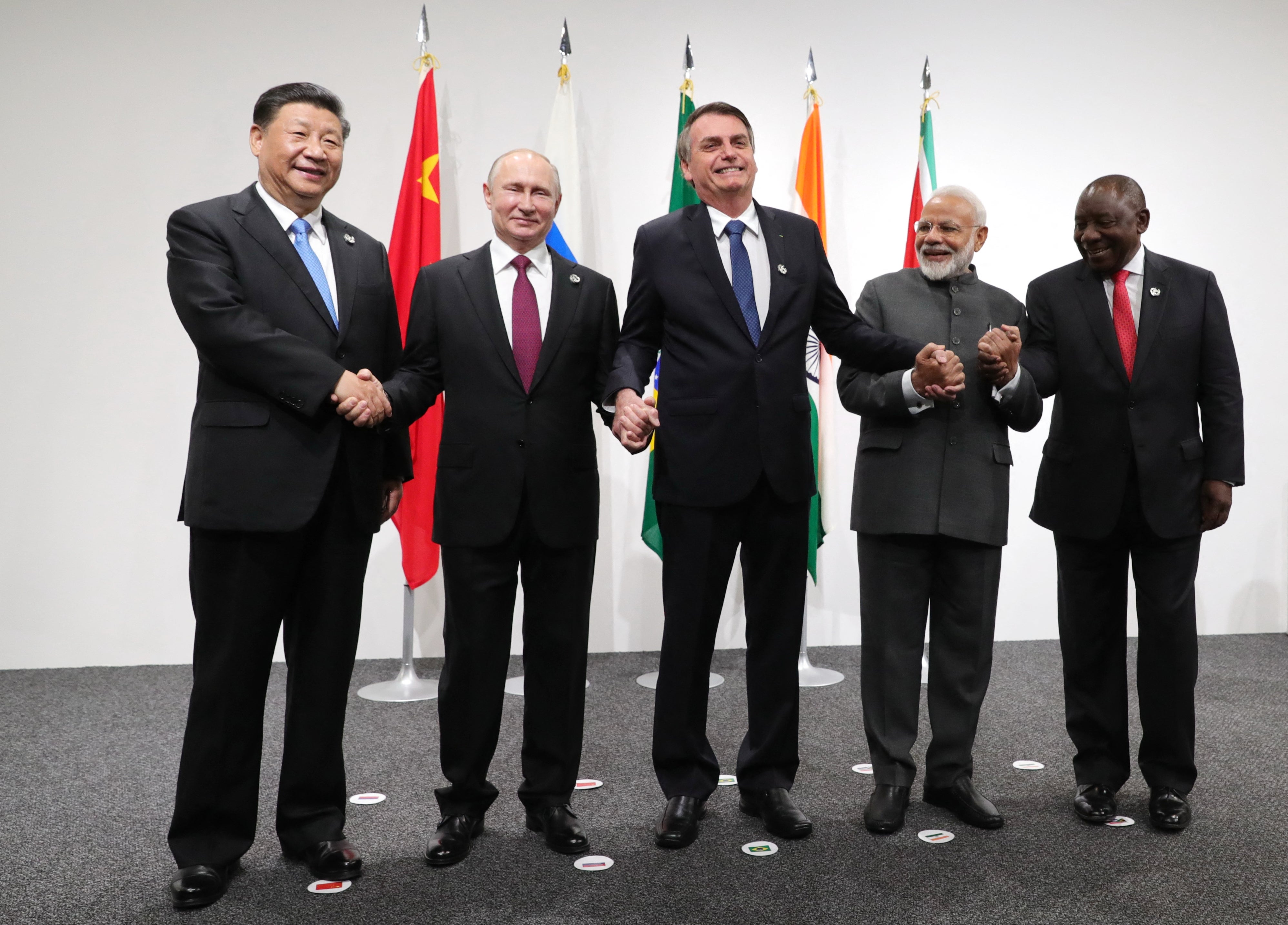 China’s Xi Jinping, Russia’s Vladimir Putin, Brazil’s Jair Bolsonaro, India's Narendra Modi and South African’s Cyril Ramaphosa shake hands during a Brics meeting at the G20 summit in Osaka on 28 June 2019